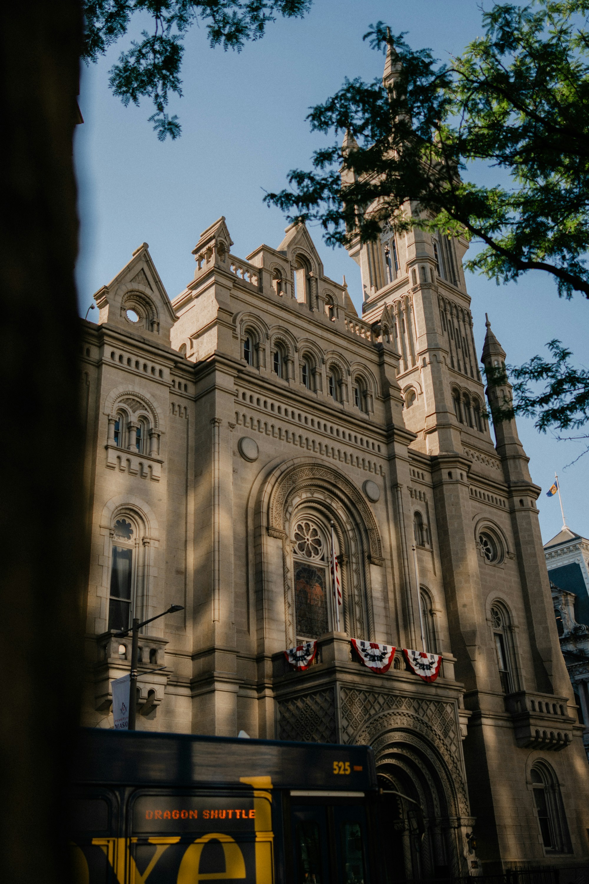 Grand historic building with intricate architecture and partial bus.