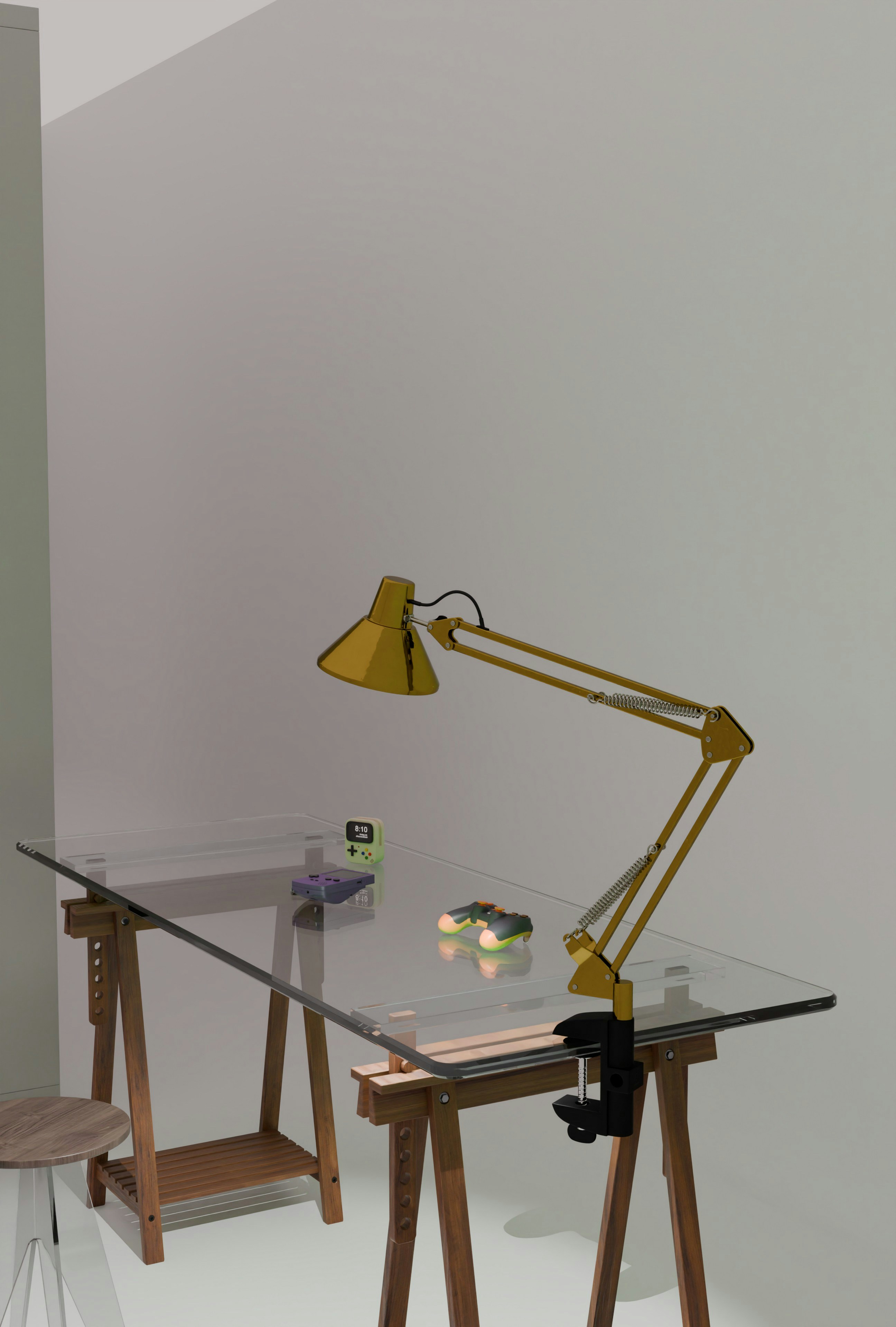 Yellow adjustable lamp on a glass desk with wooden legs.