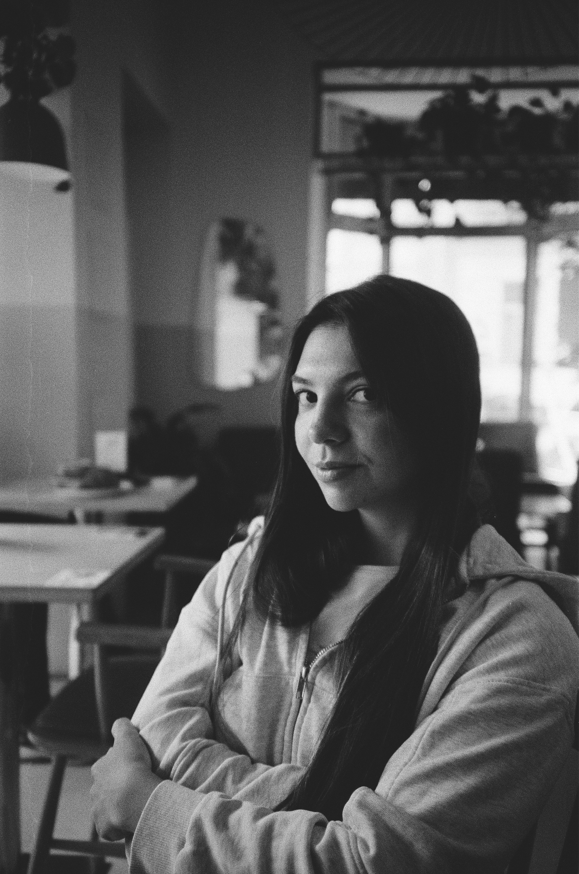 A young woman with long hair sitting in a cafe