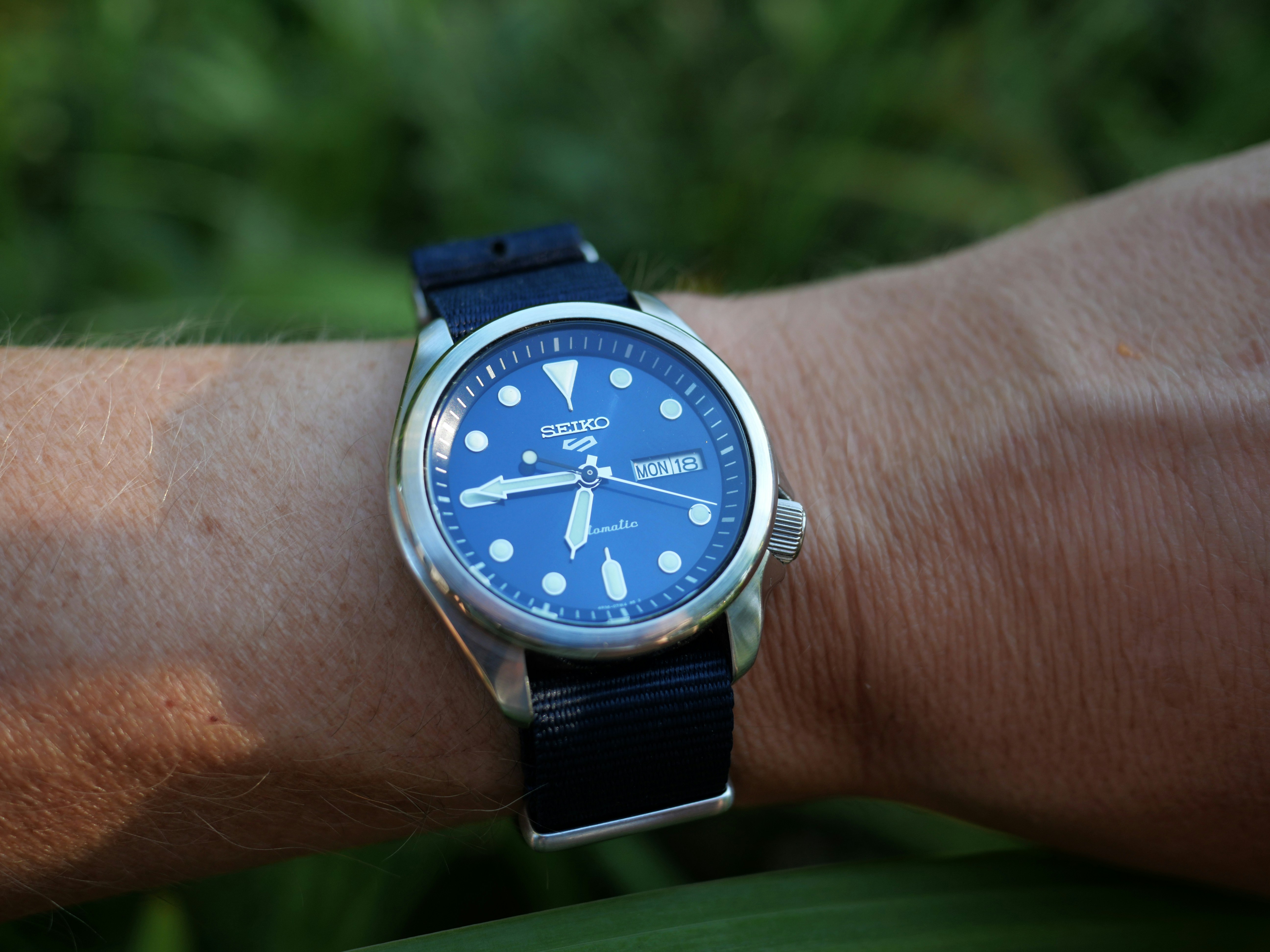 A blue-dial Seiko 5 Sports on the wrist