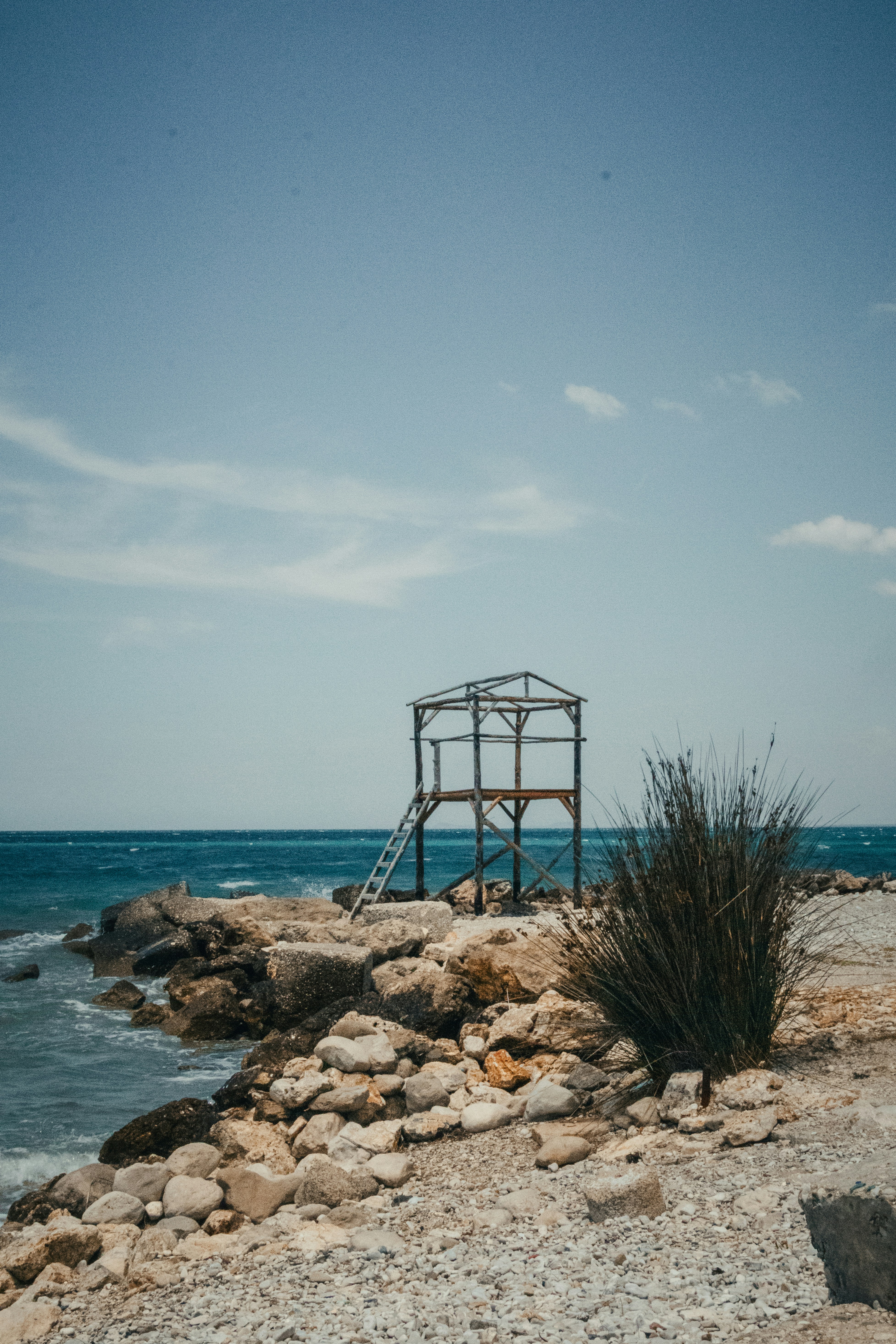 Rustic wooden structure on a rocky shore by the sea
