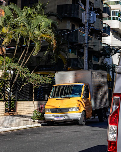 A yellow delivery truck parked on a city street