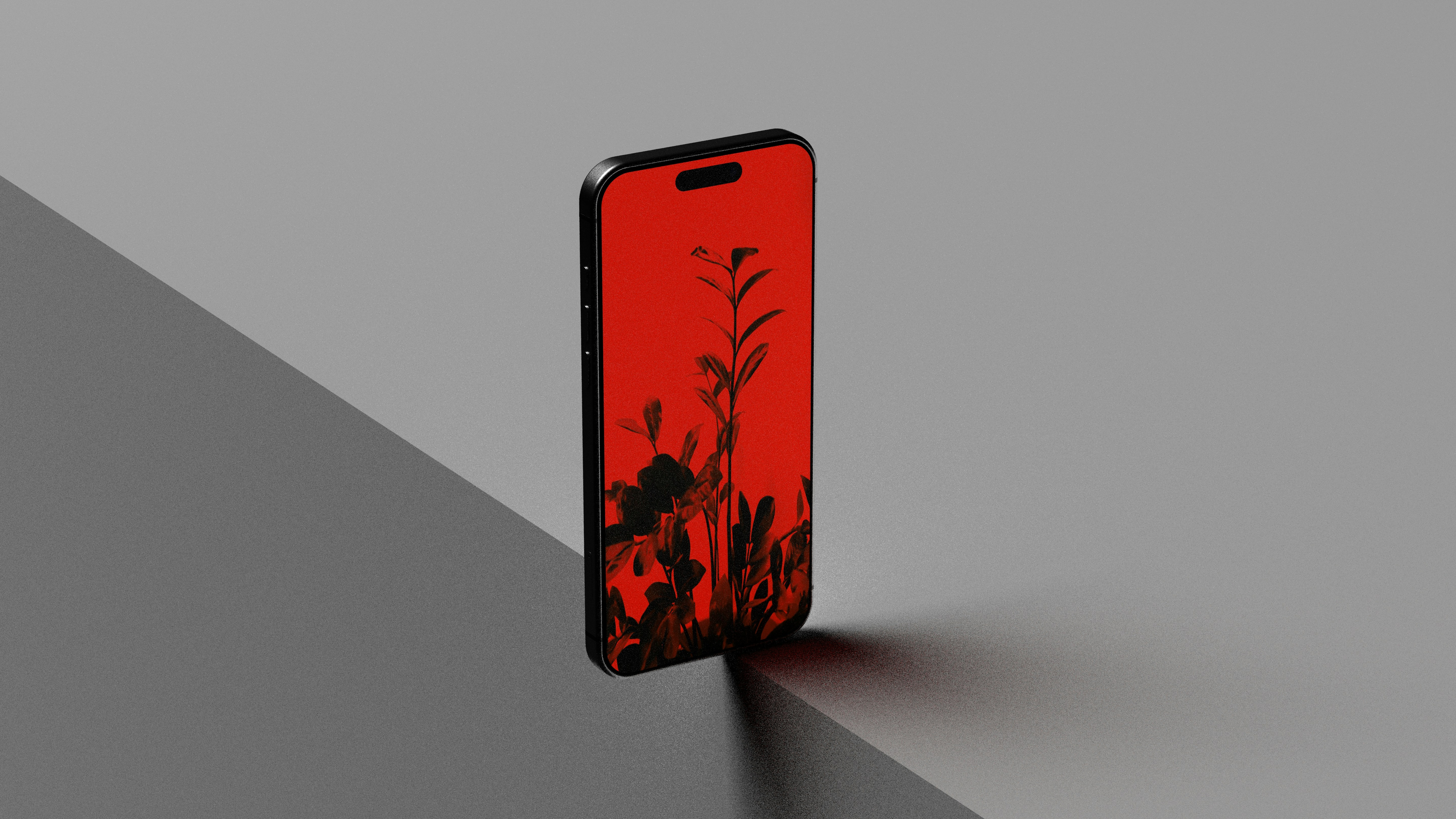 A smartphone with a red screen showing plant silhouettes.