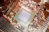 Illuminated microchip on a complex electronic circuit board