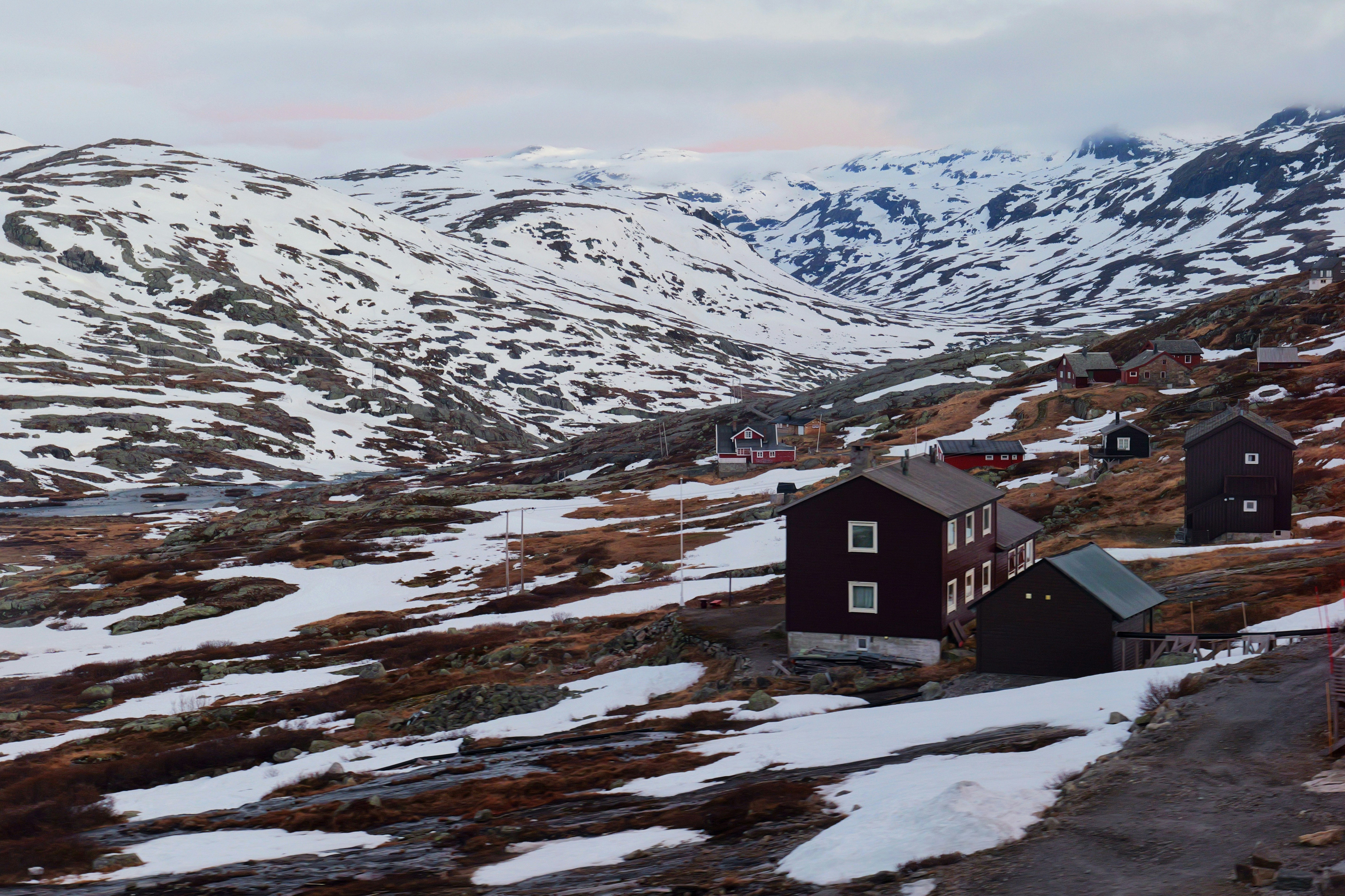 Houses nestled in a snowy mountain valley.