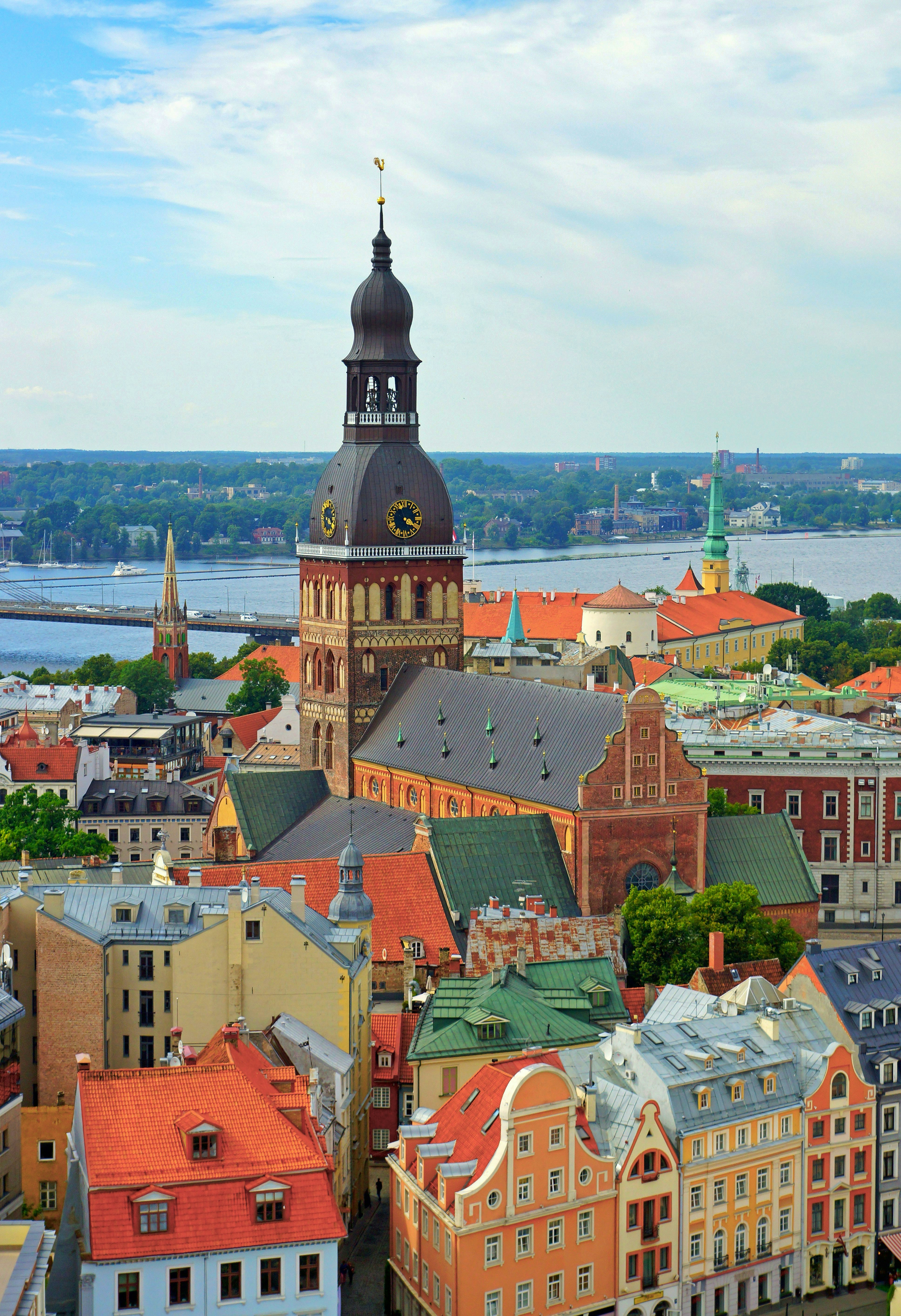 Historic city skyline with a grand cathedral and colorful rooftops.