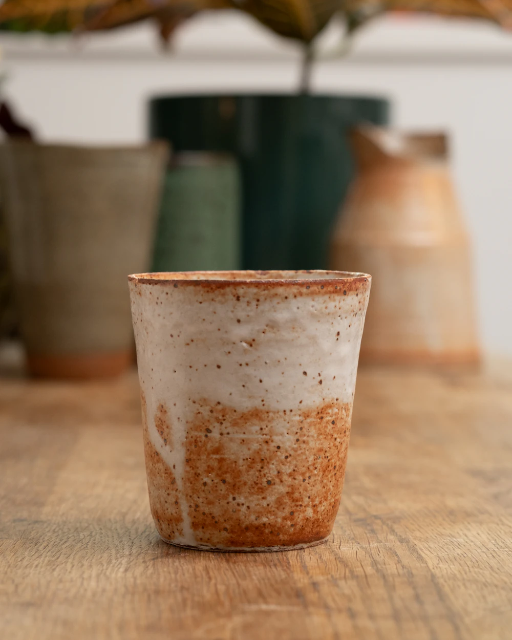 A stoneware cup on the wooden bar