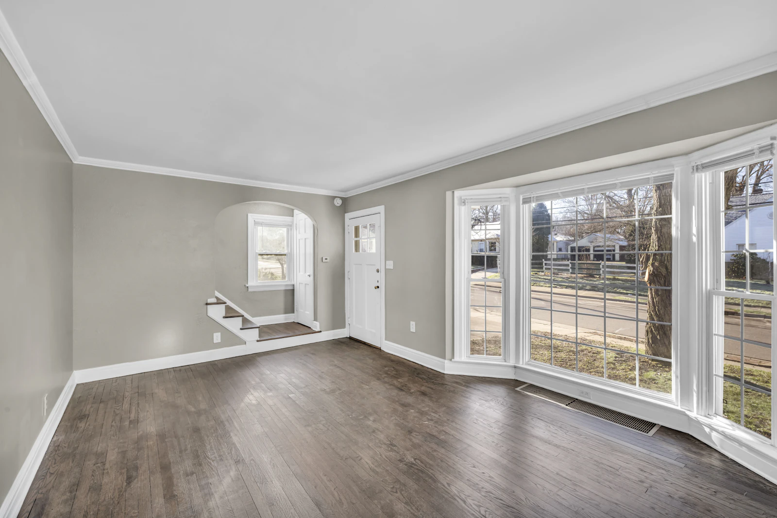 Empty room with a bay window and new wood floors