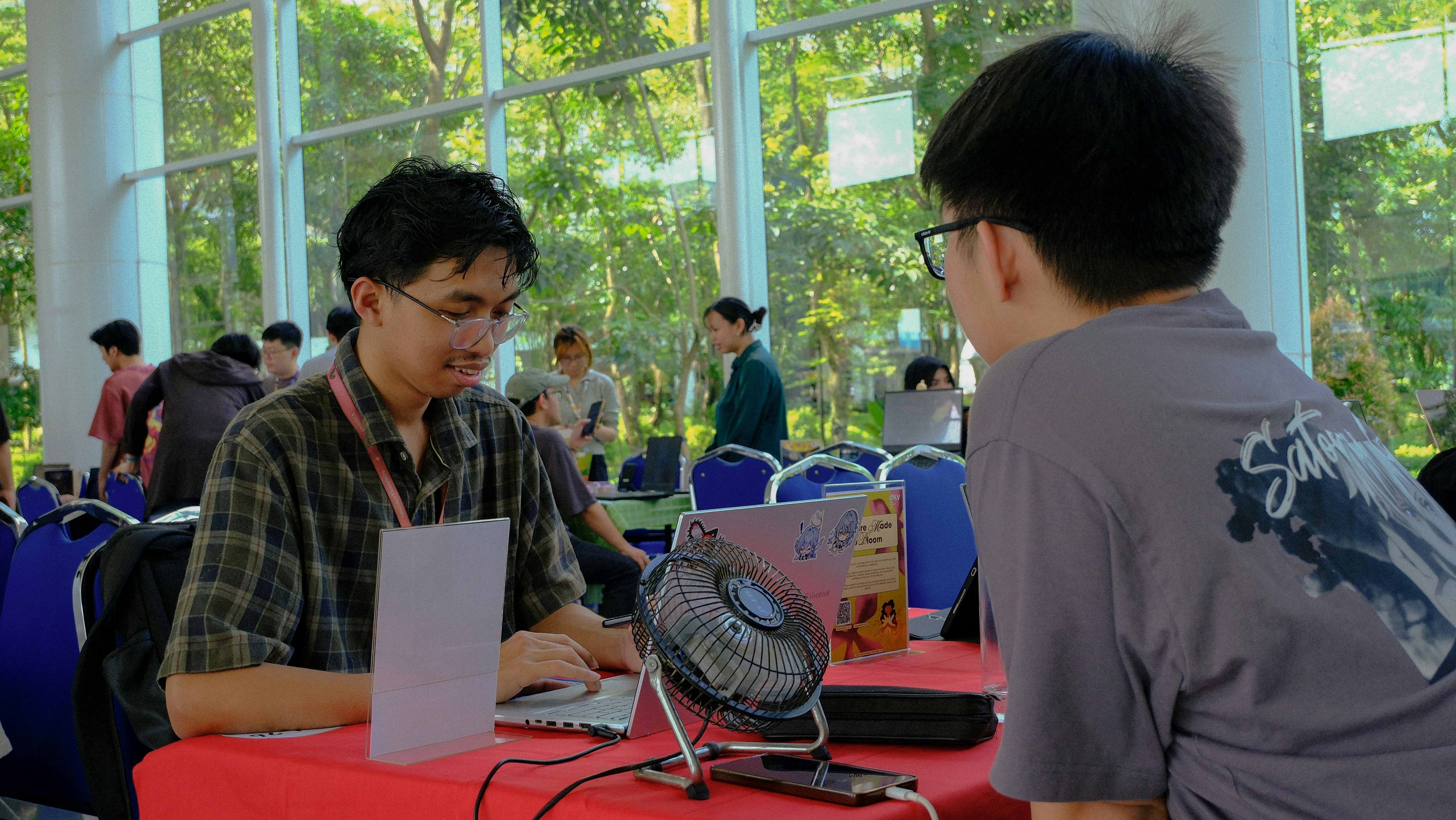 Two men at a table with a laptop.