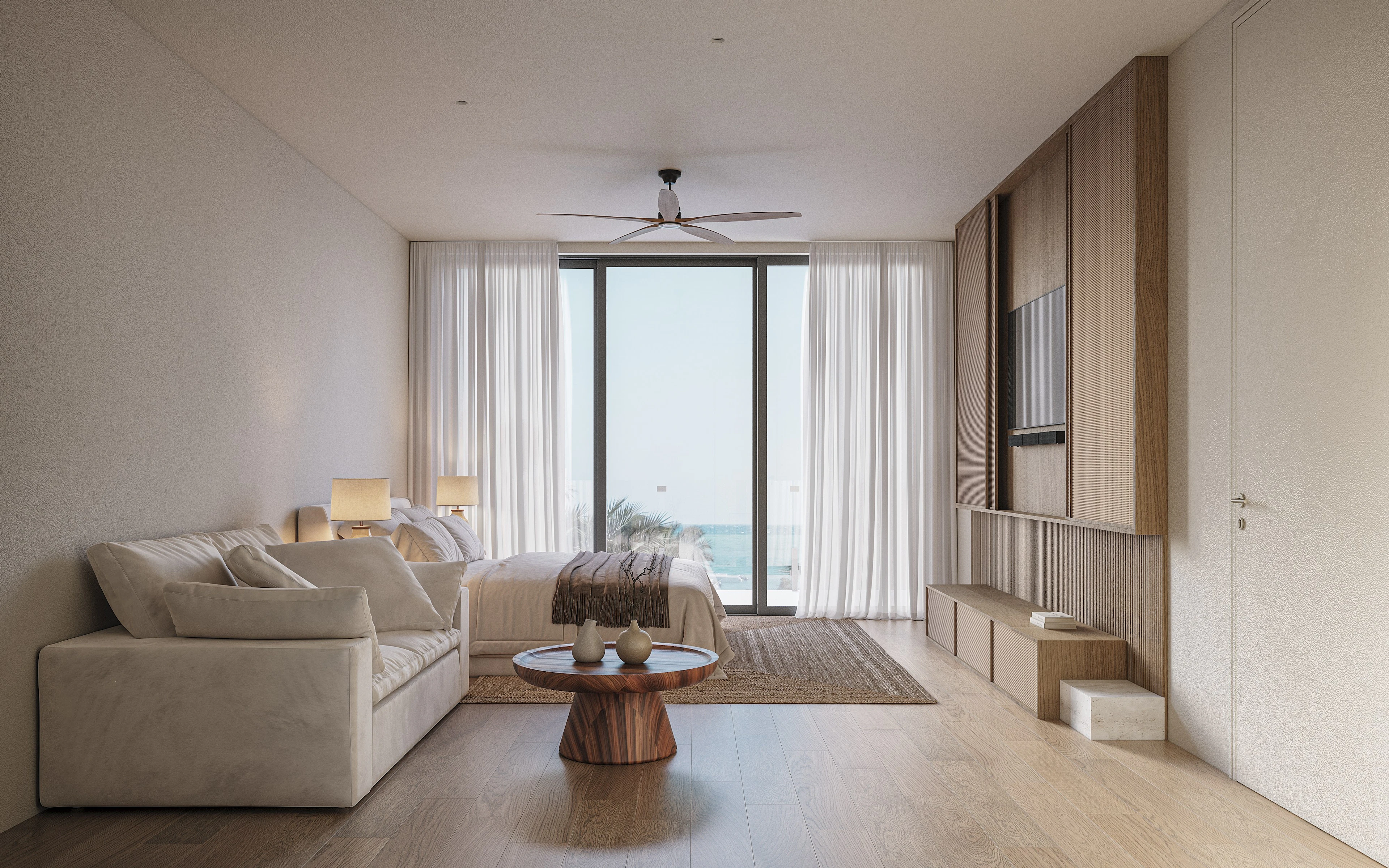 Bright suite with a sofa, wooden floor and an ocean view