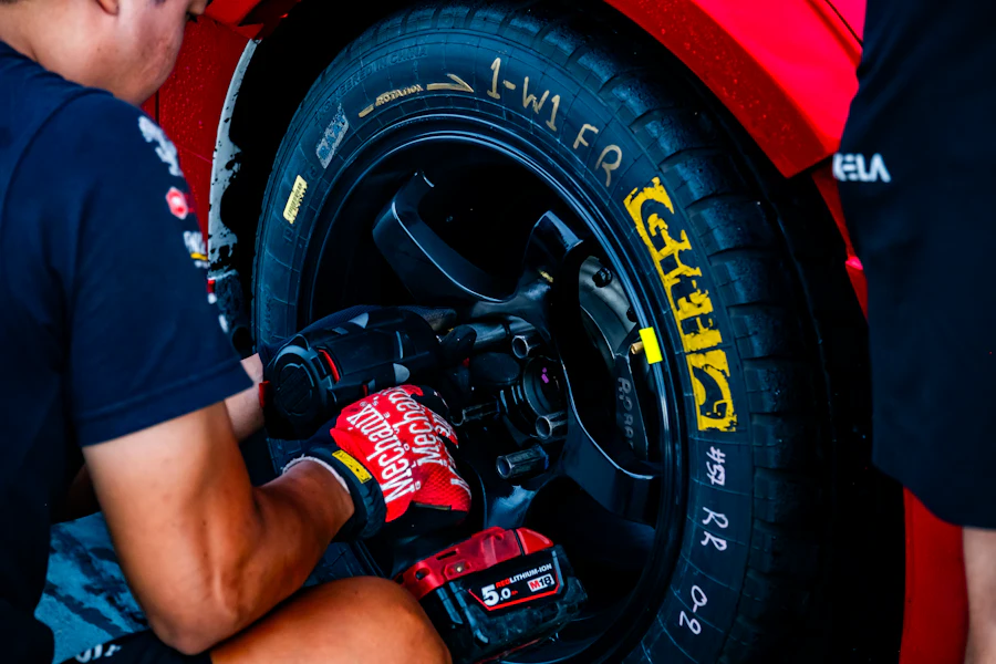 A mechanic tightening a wheel
