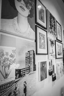 Eclectic black and white art display featuring portraits and cityscapes