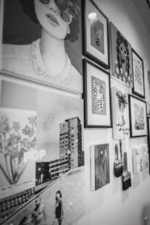 Eclectic black and white art display featuring portraits and cityscapes