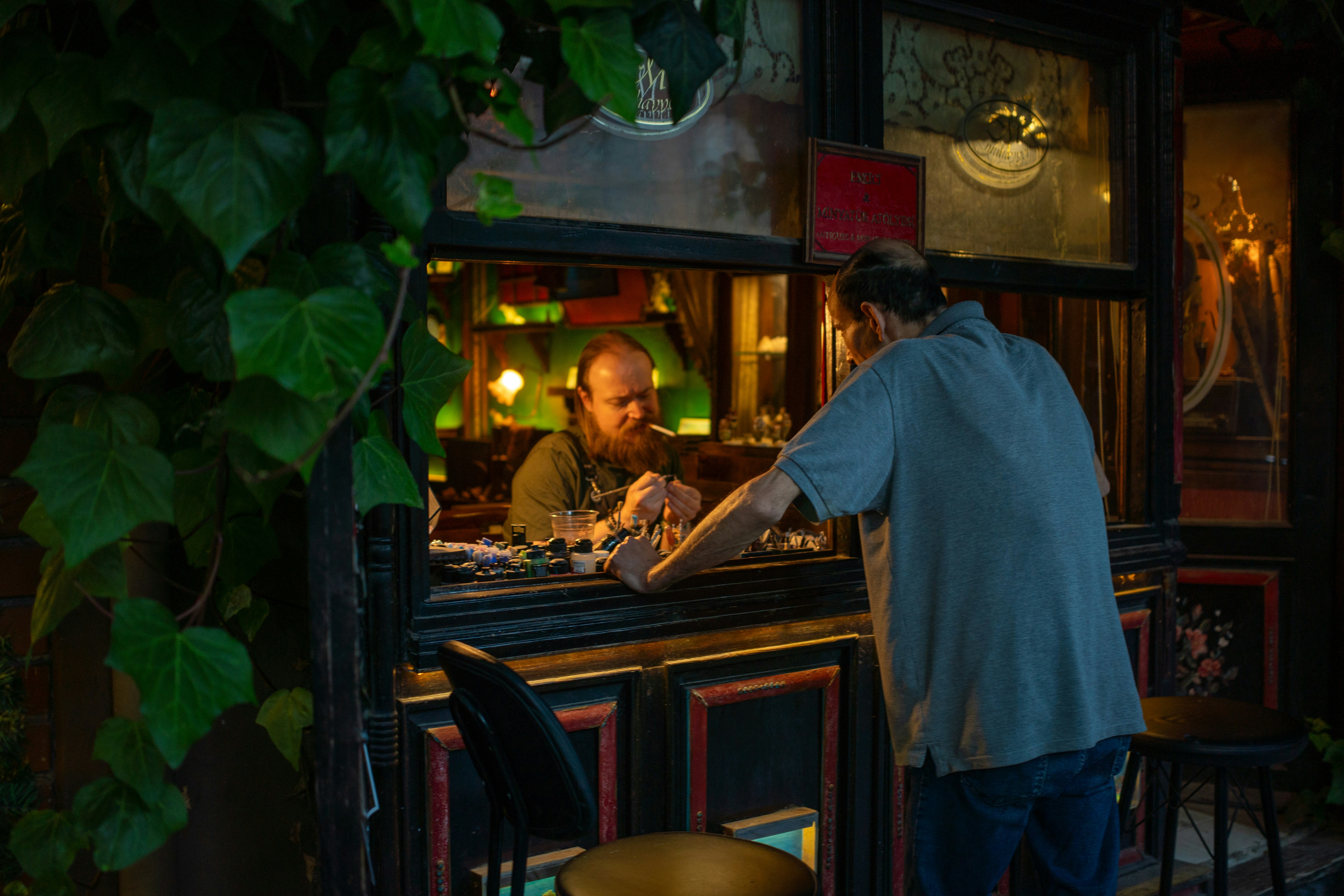 Customer talking to a bartender through a bar window