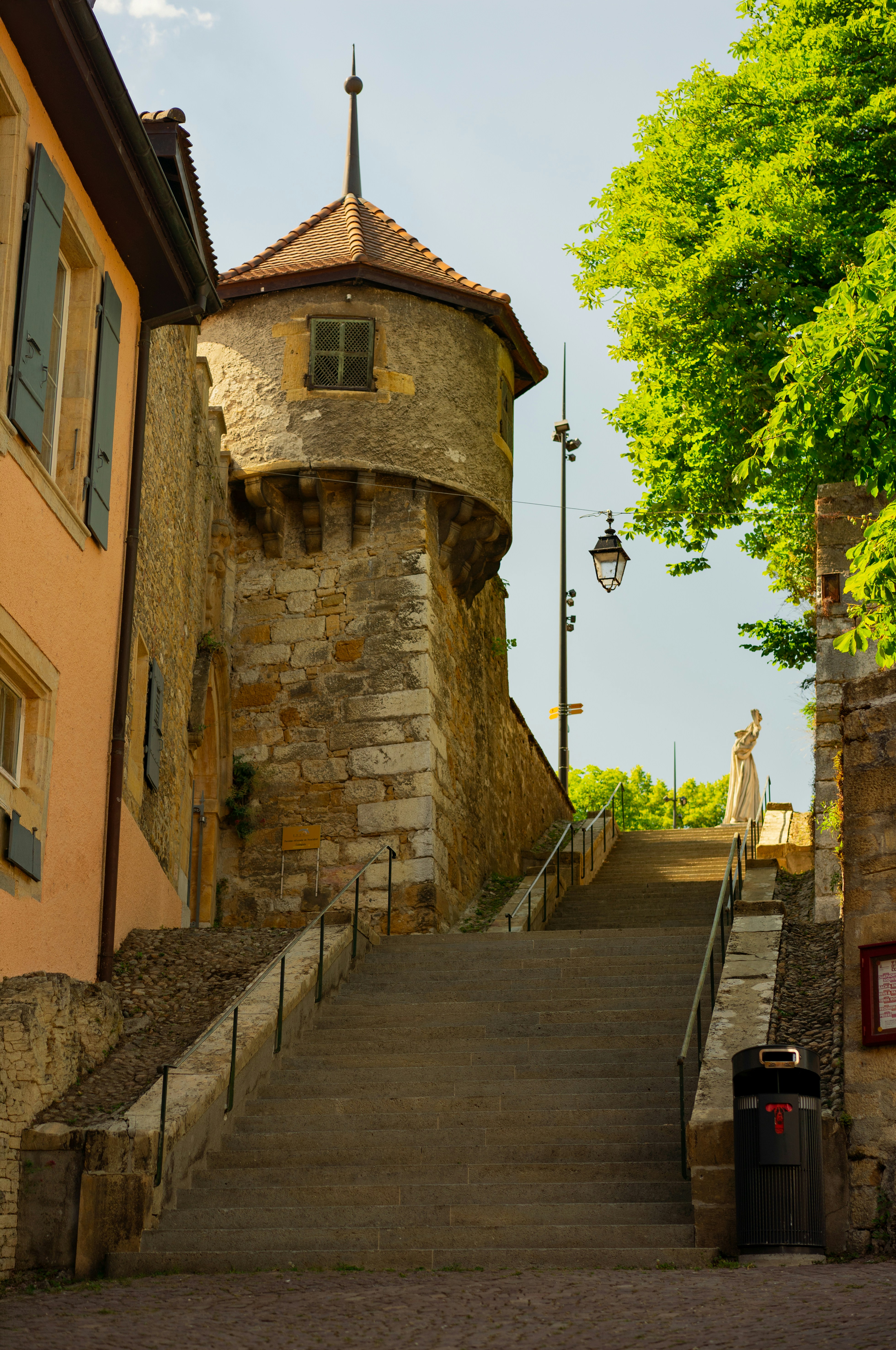 Historic stone tower beside a long outdoor staircase.
