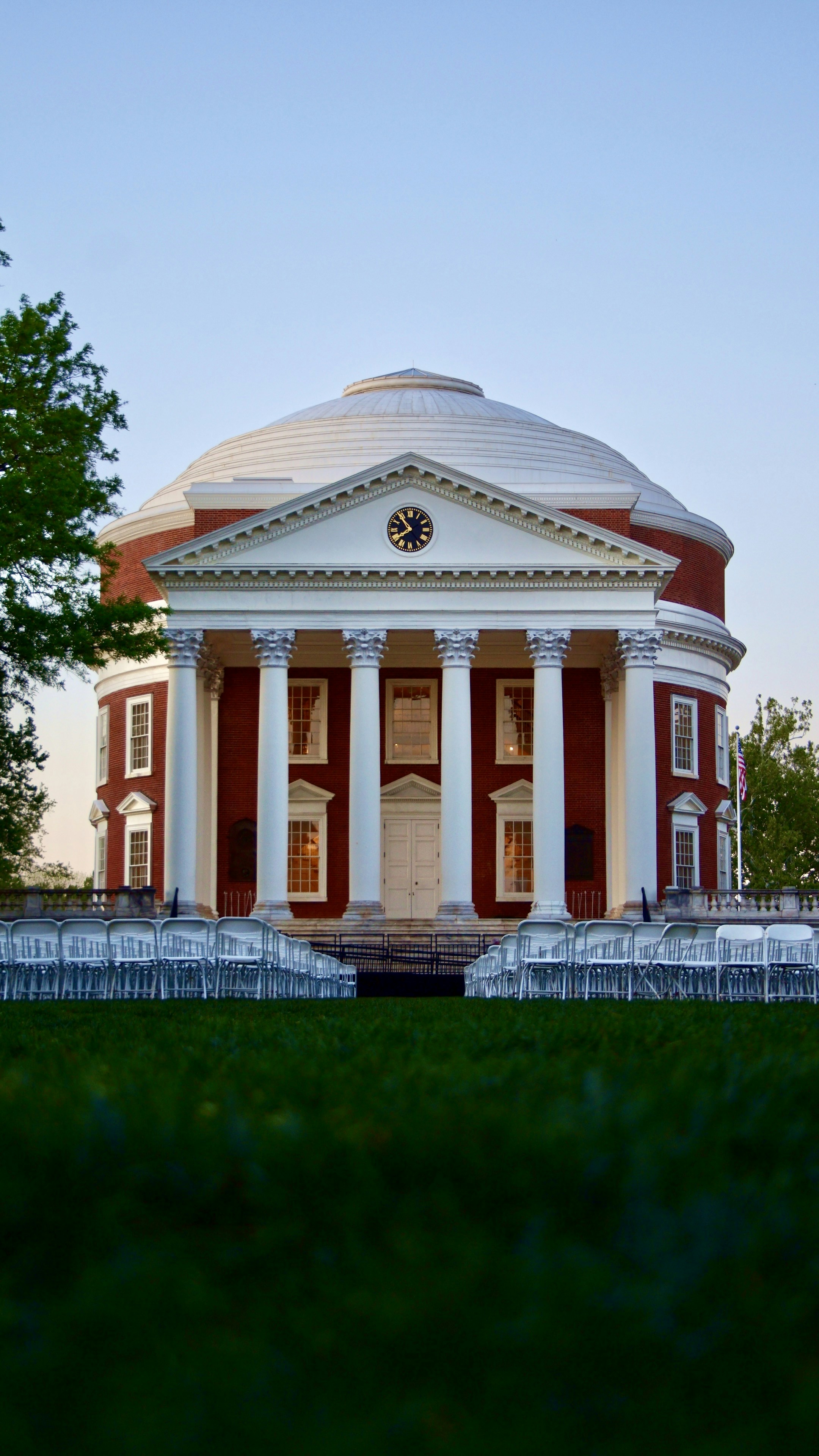 A grand, domed building with white columns and a clock