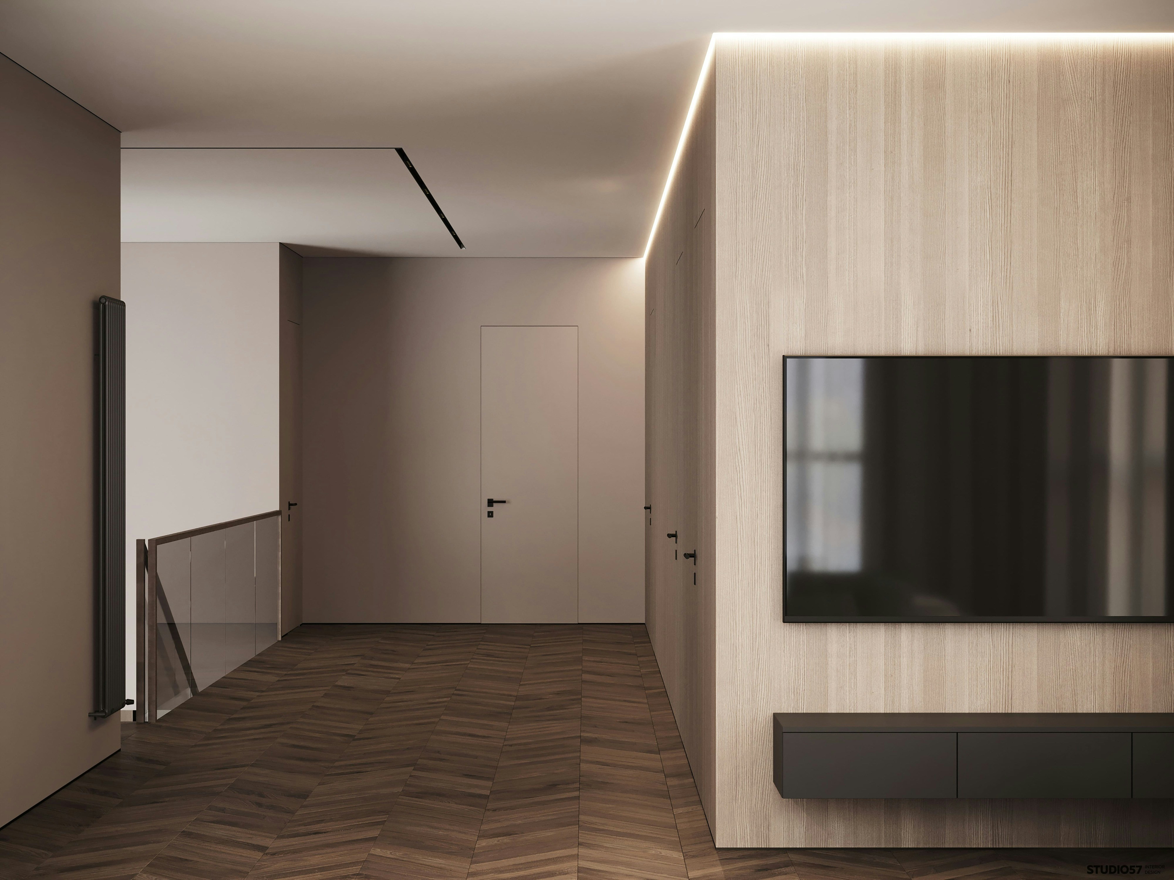 Un salon au plancher de bois en chevrons, devant un mur lambrissé