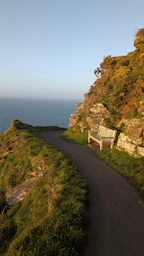 Notes along the way wooden bench on a scenic cliff path by the ocean.