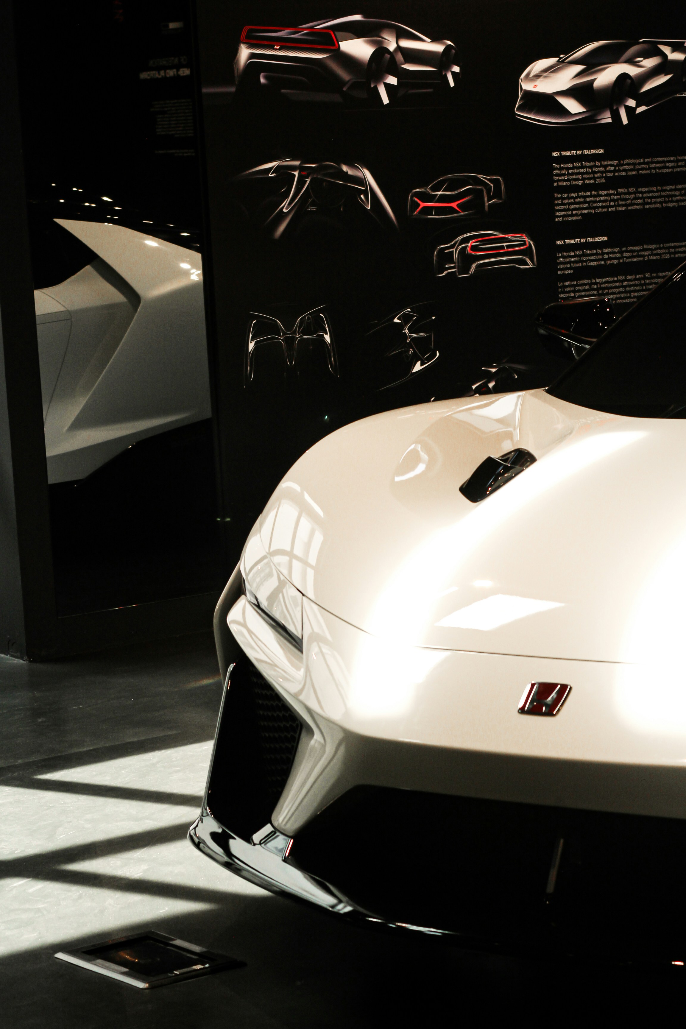 Sleek white sports car displayed with automotive design concepts