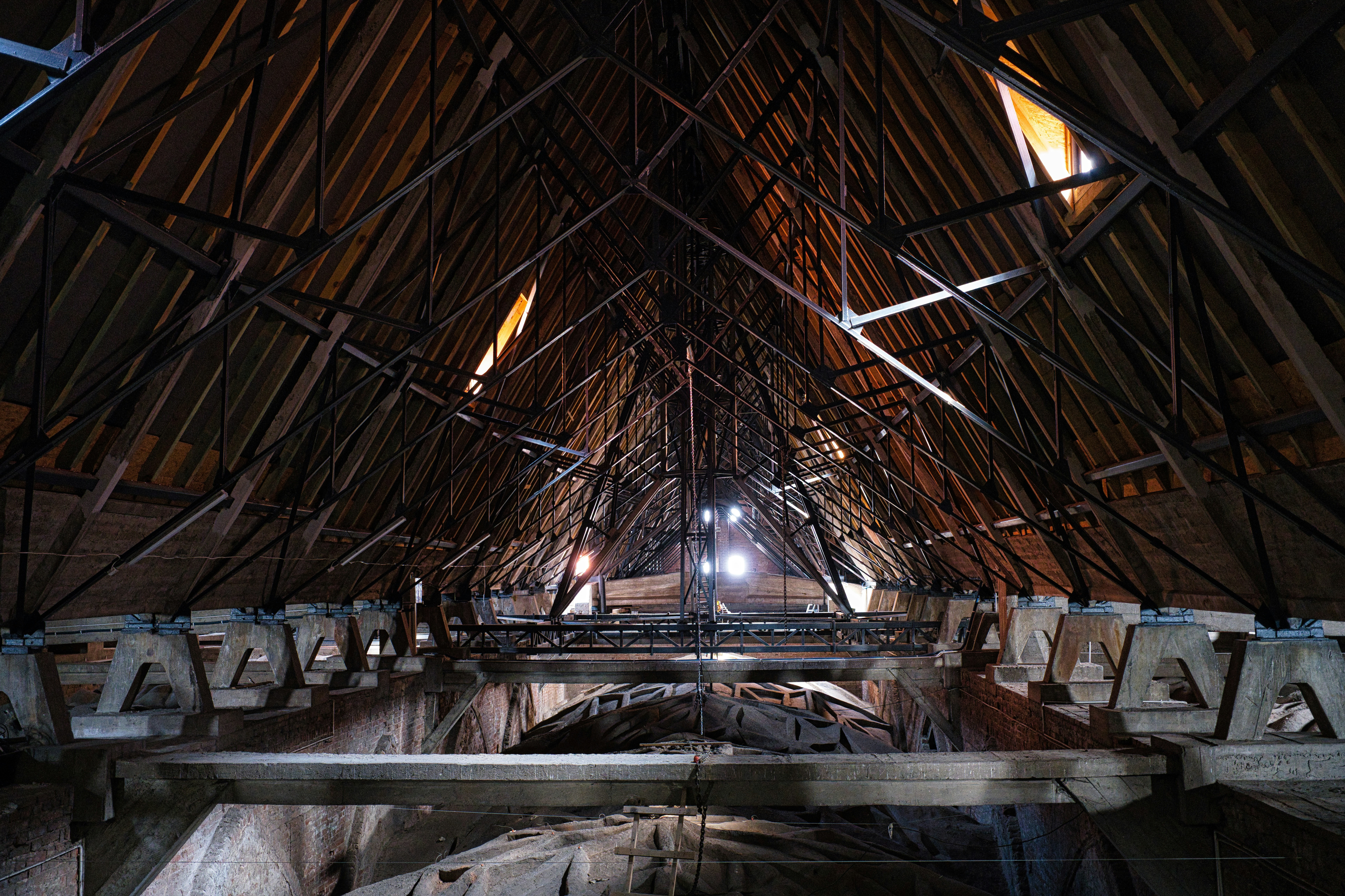Intricate wooden roof structure of an old building.