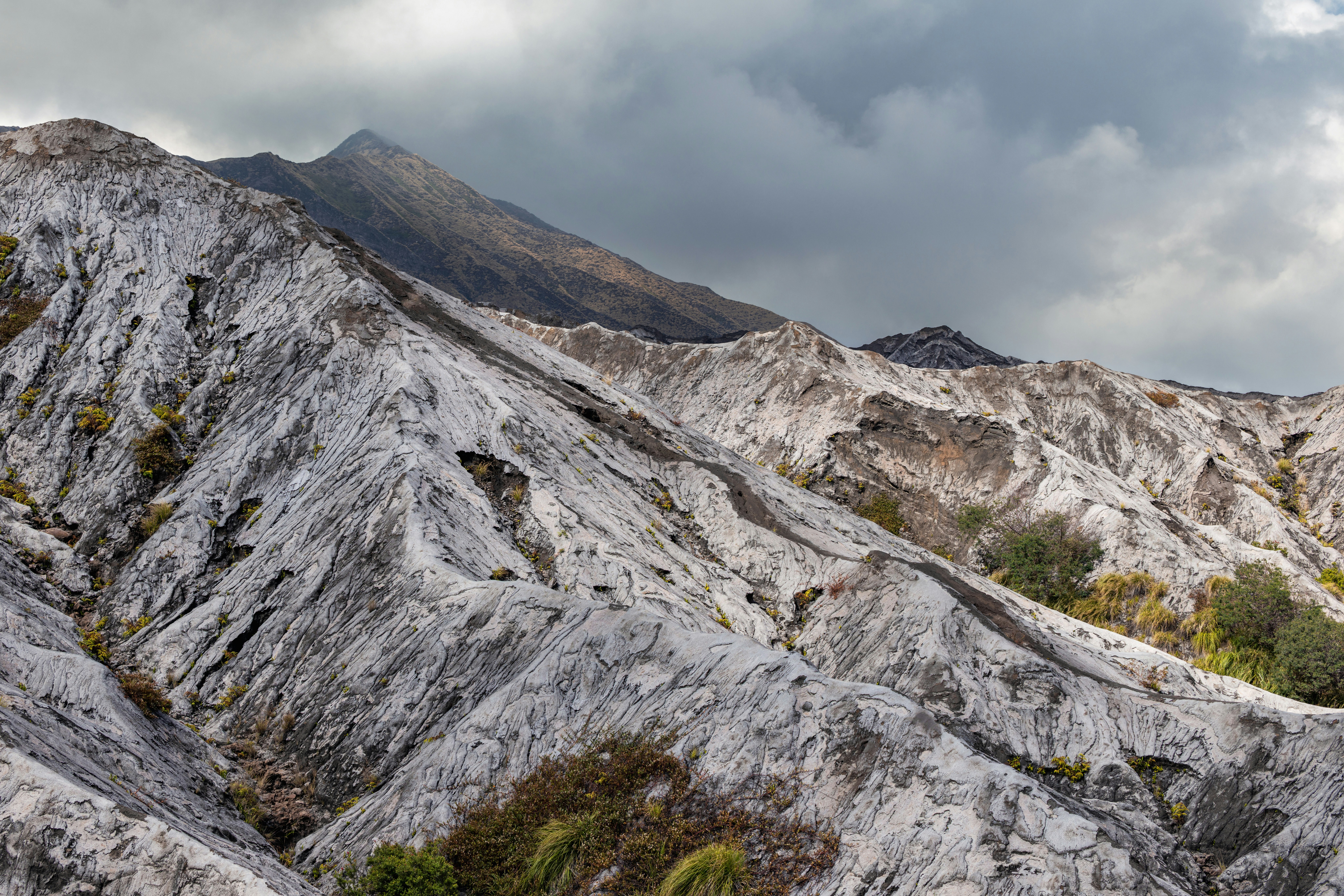 Rugged white mountains under a cloudy sky.