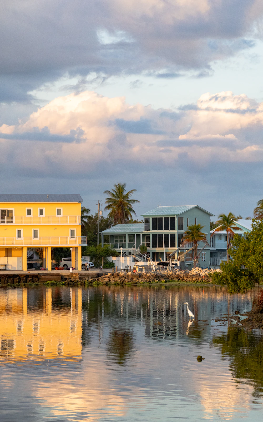 Coastal homes reflected in calm water