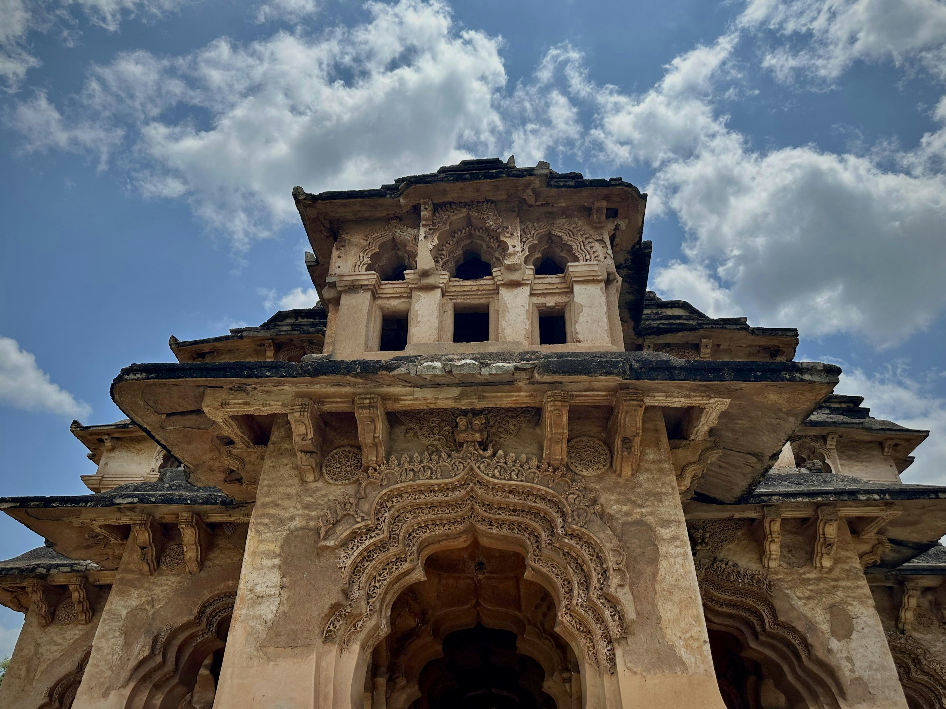 Ornate ancient stone architecture under a blue sky.