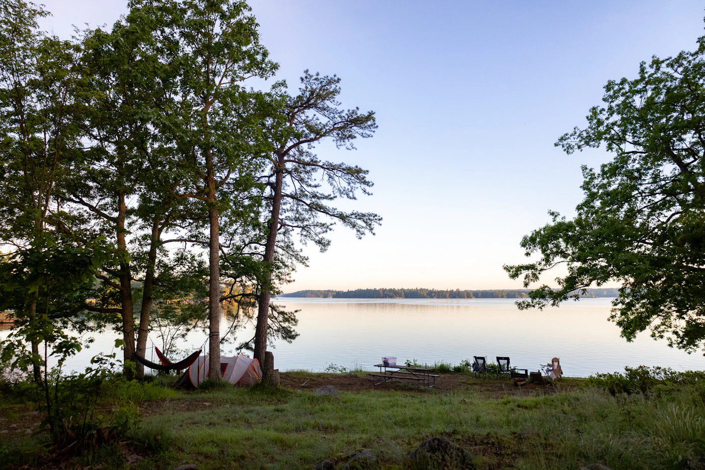 Outdoor camping setup beside calm water