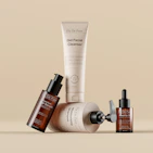 Various skincare and beauty products arranged on a beige background.