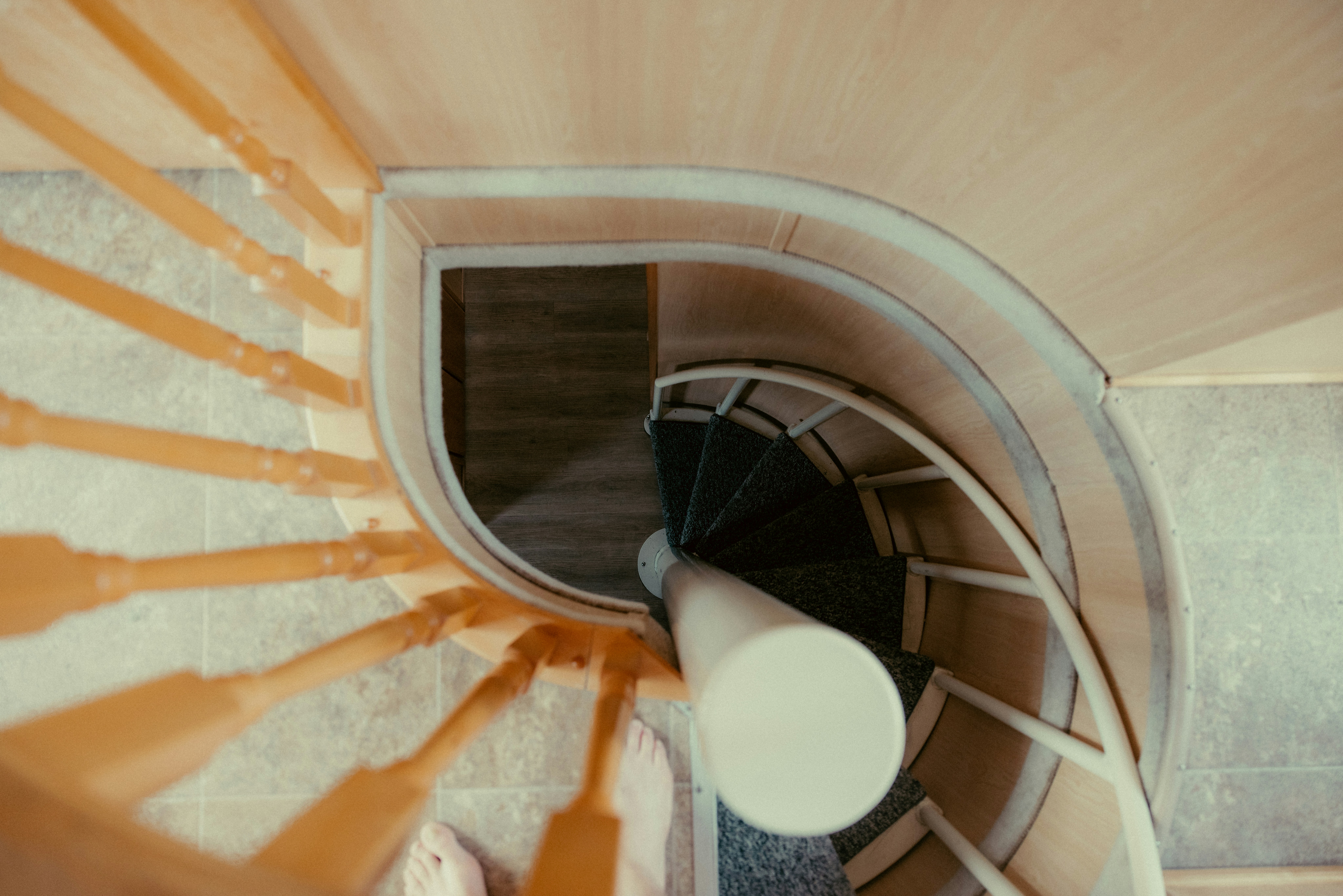 A wooden spiral staircase viewed from above.