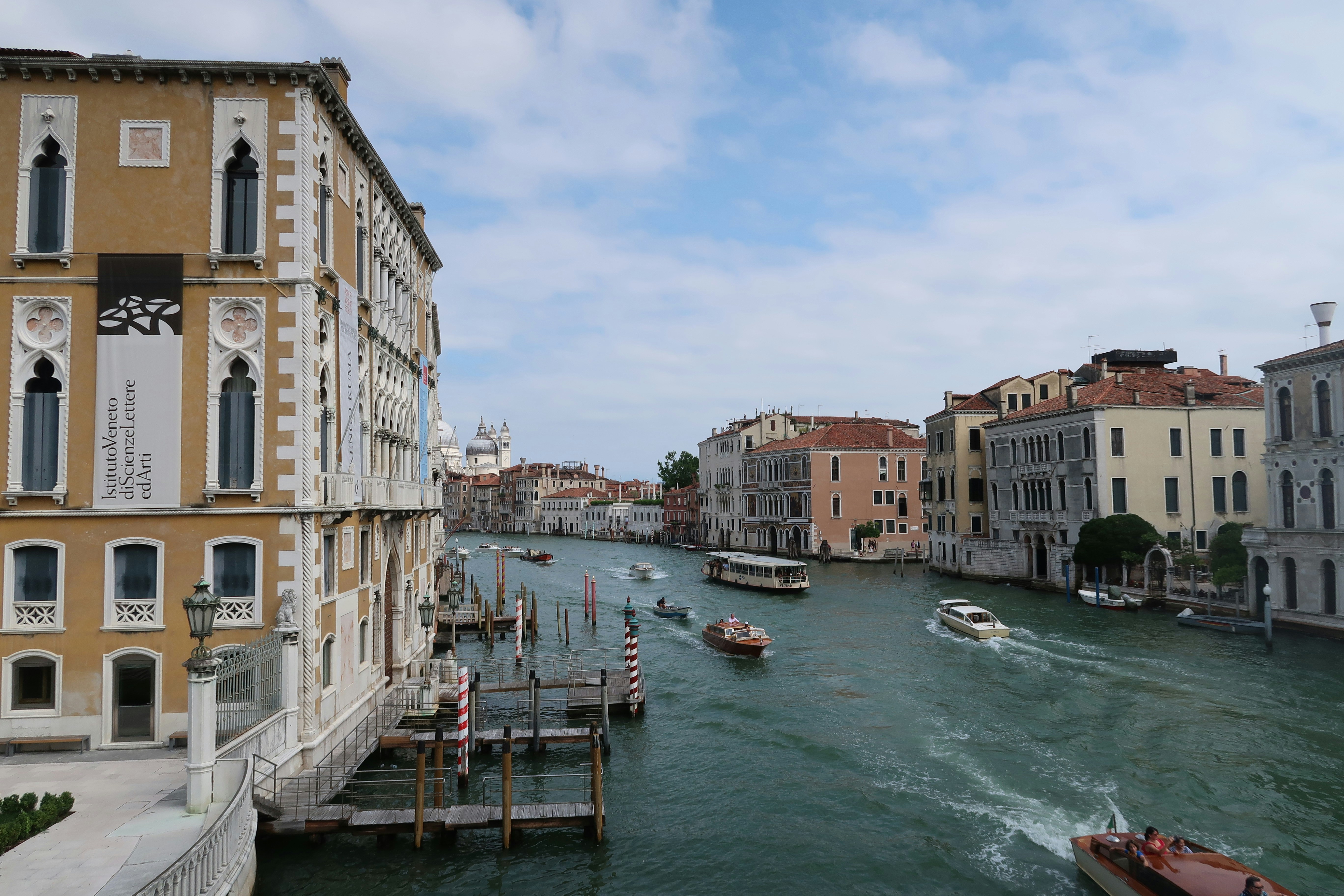 Boats on a venetian canal with ornate buildings