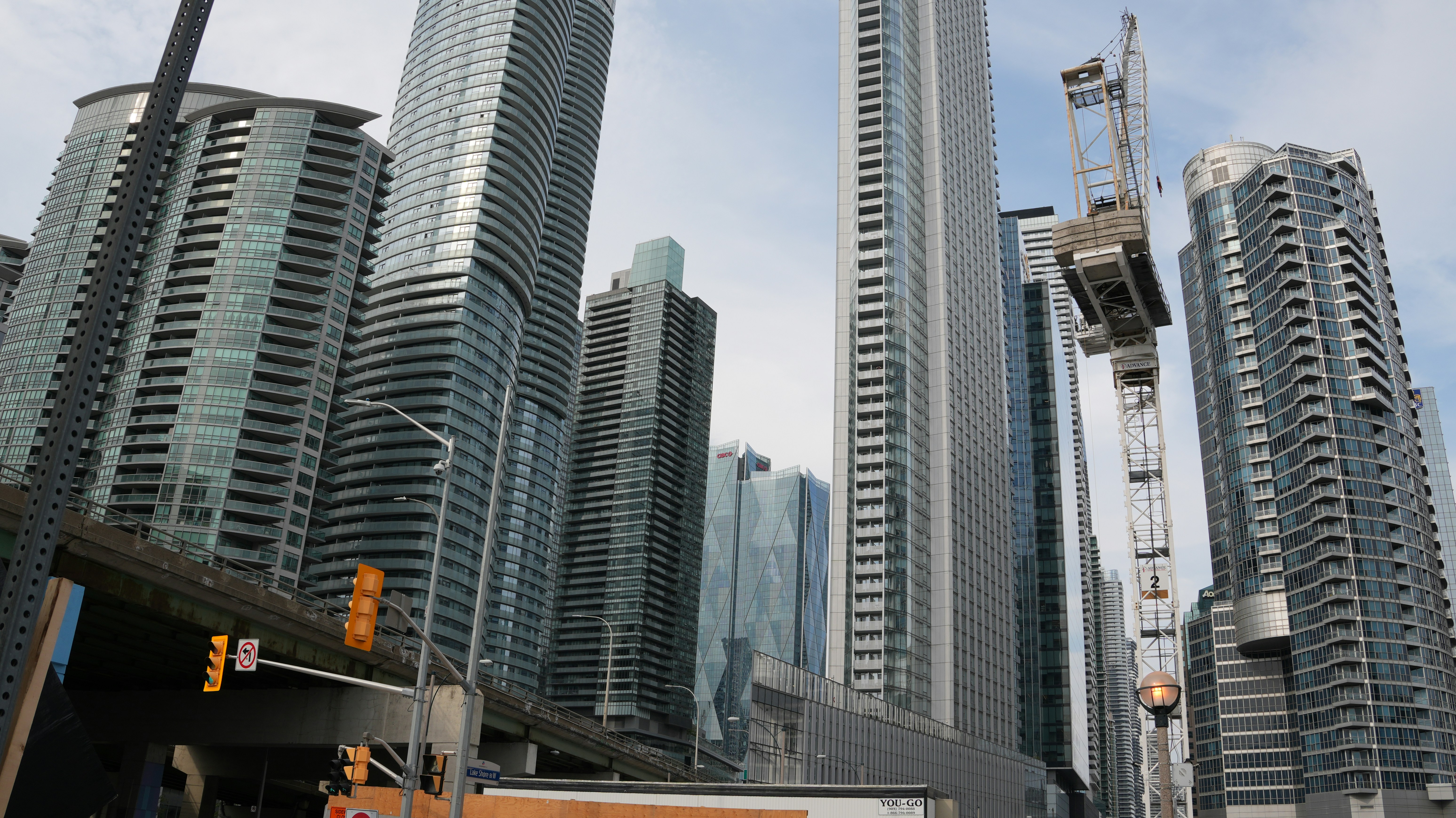 Modern towers and a crane in an evolving city skyline