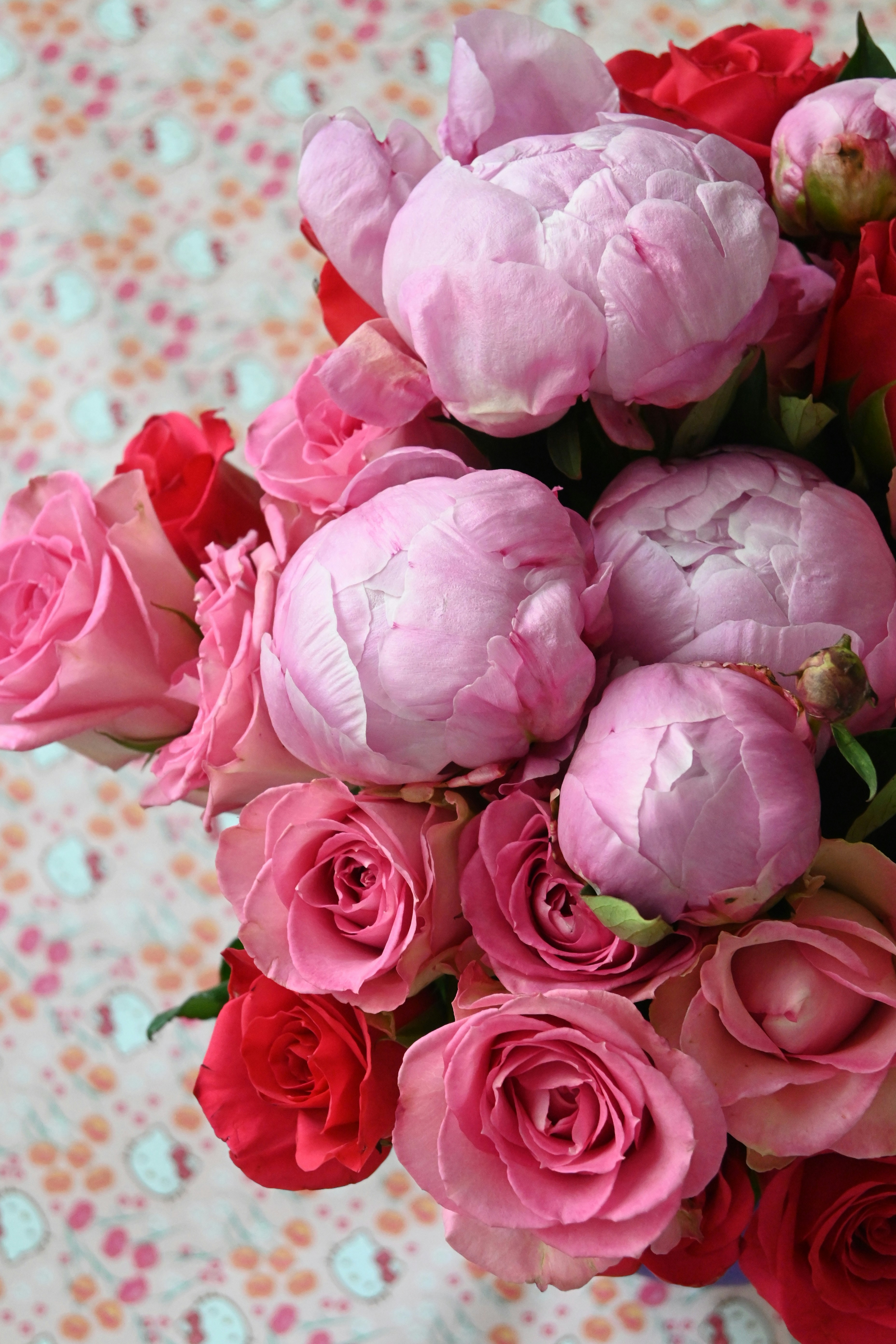 A beautiful bouquet of pink peonies and red roses