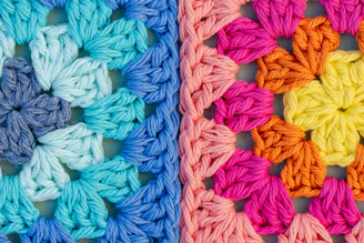 Colorful crochet granny squares in cool and warm tones