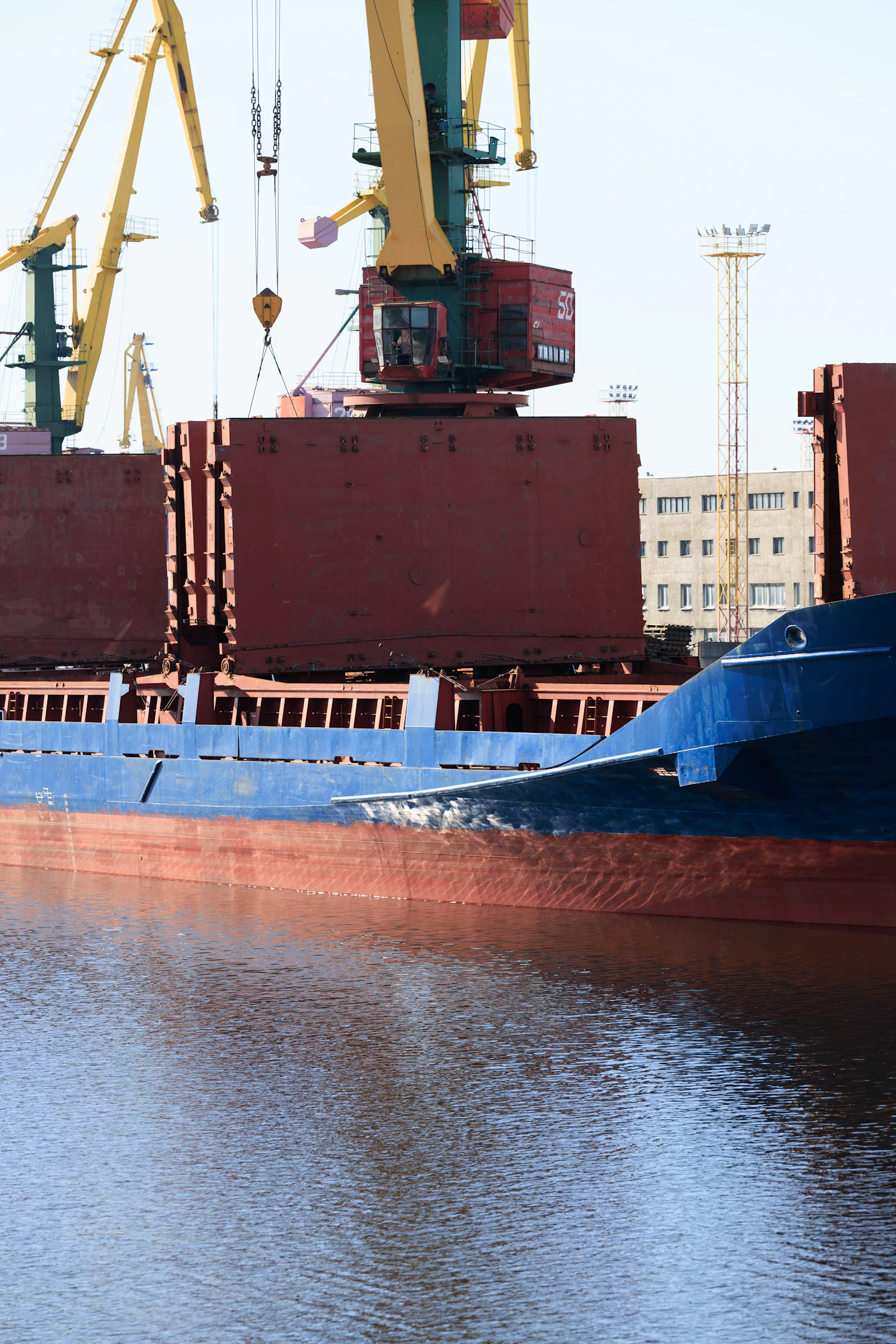 Hafenkräne beladen ein Schiff