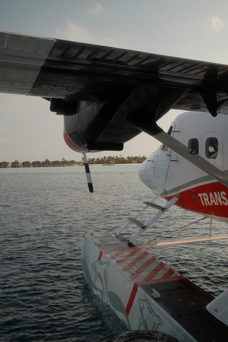 Seaplane float and wing over calm tropical ocean water