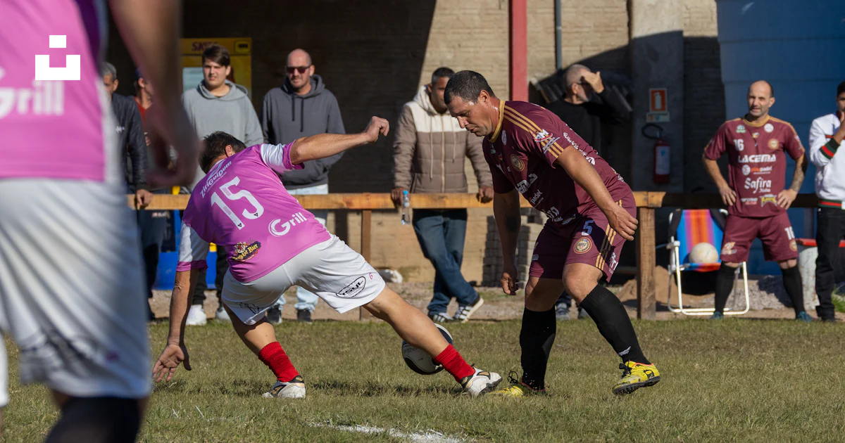 Soccer players compete for the ball during an outdoor game. photo ...