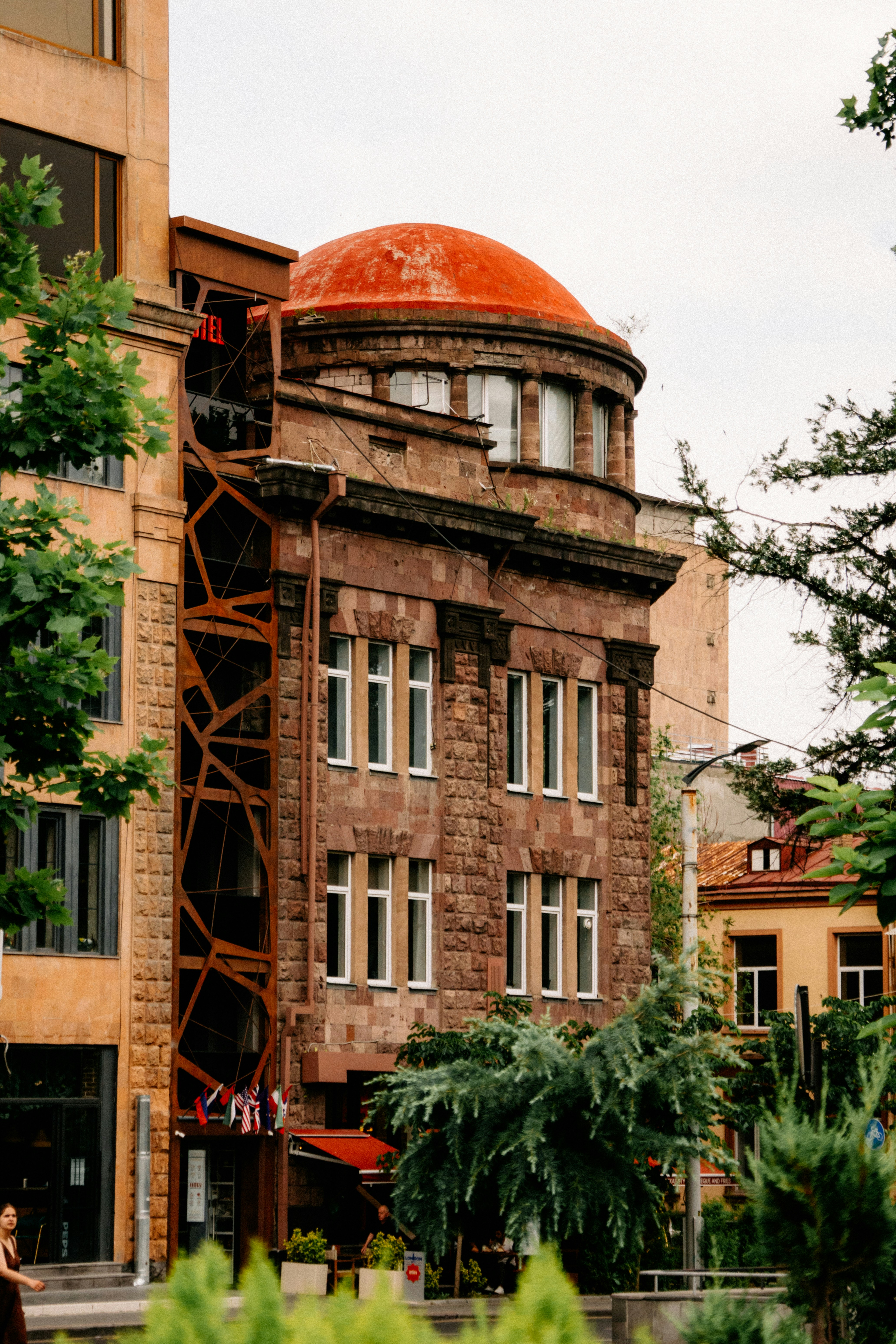 Stone building with red dome and unique external staircase