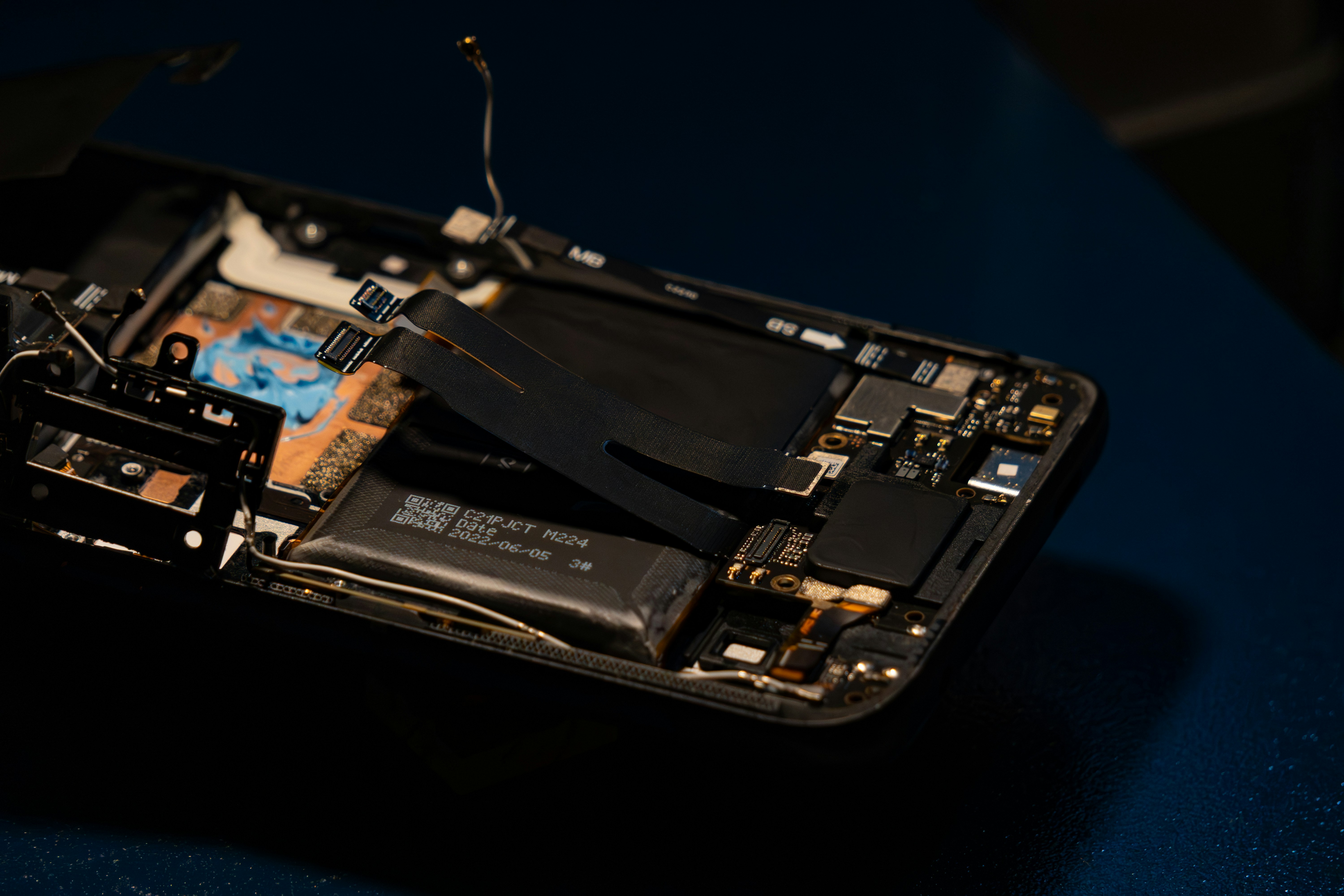 Disassembled iPhone showing battery and internal components