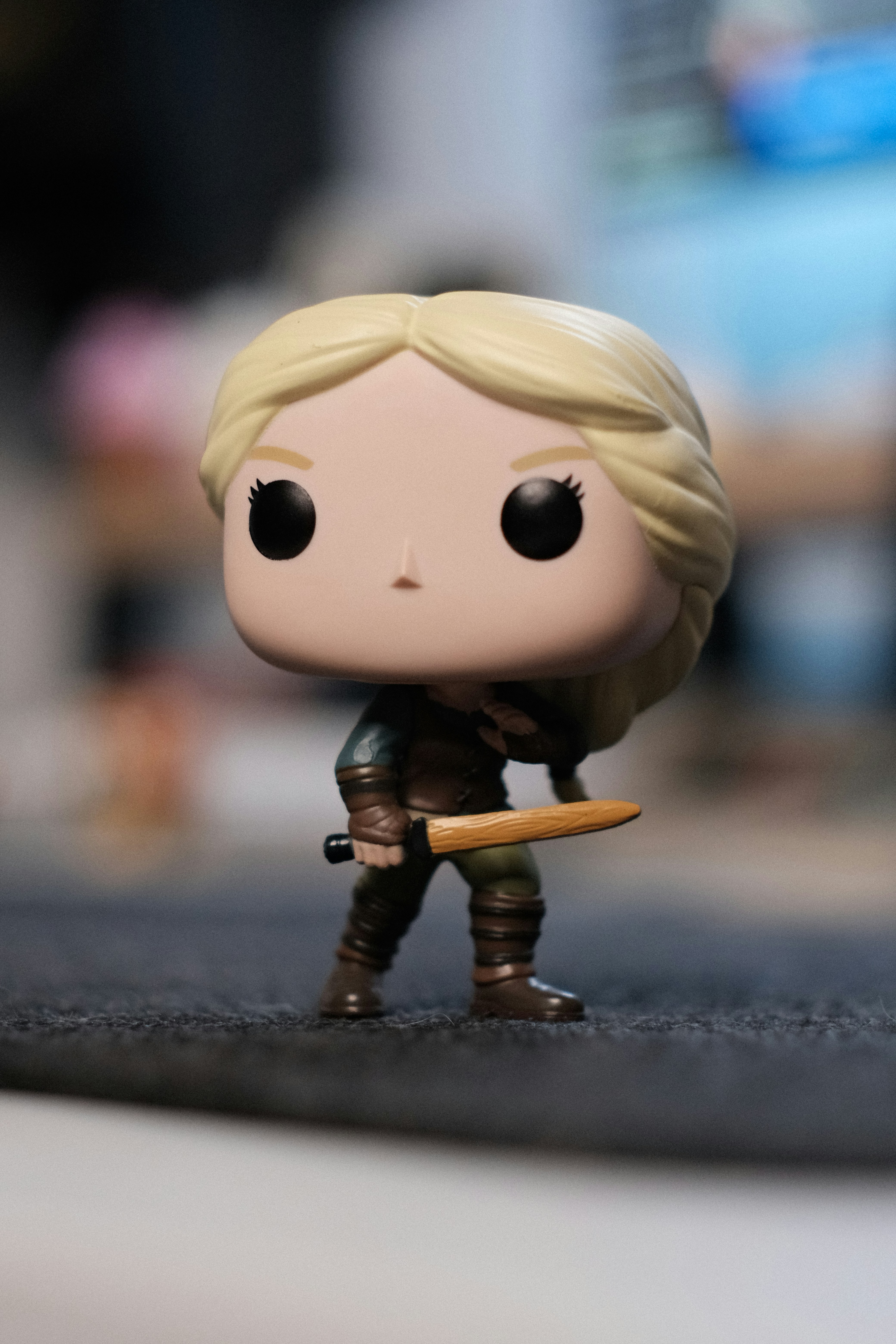 A funko pop figure with blonde hair holding a sword.