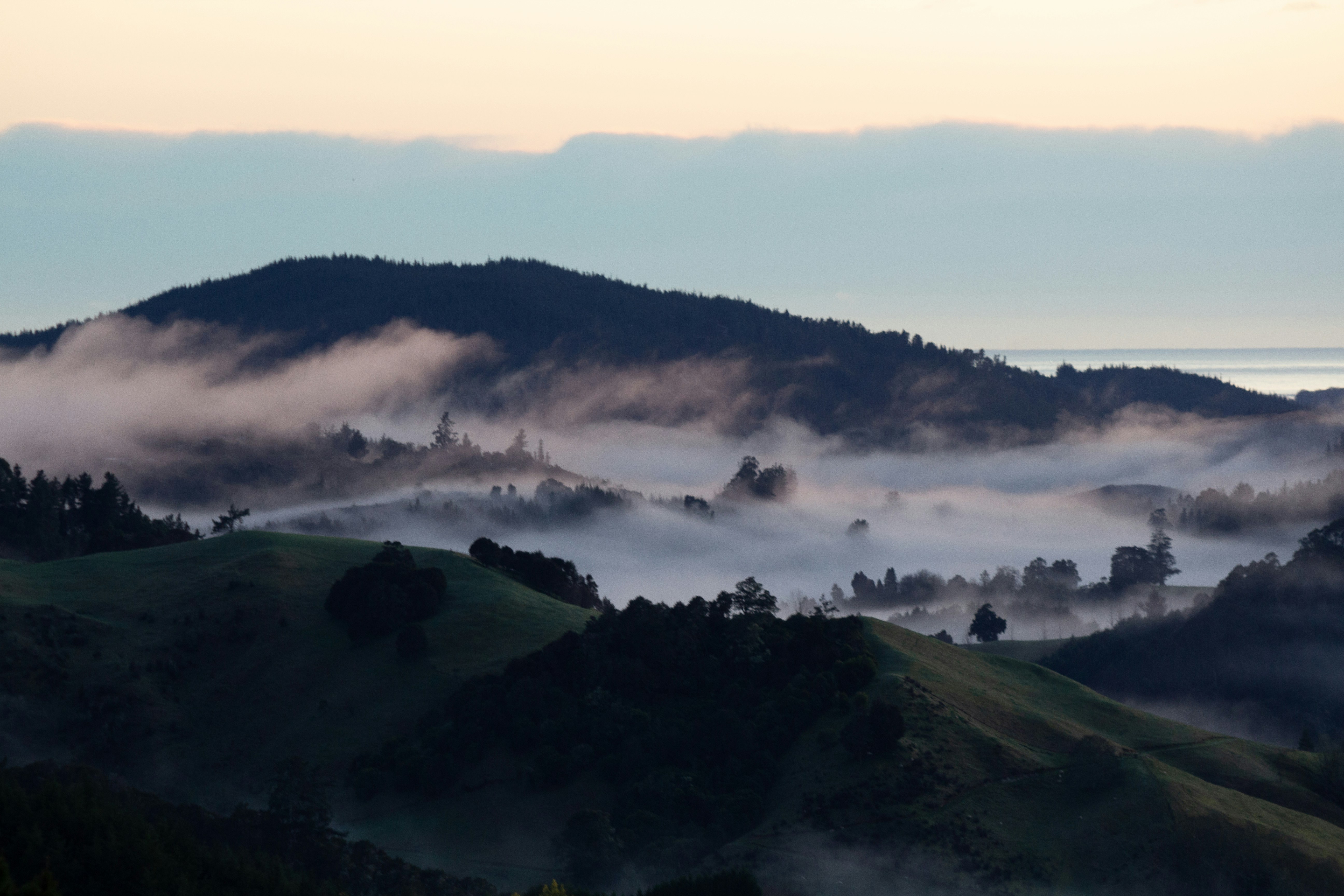 Foggy valleys and rolling mountains at dawn.