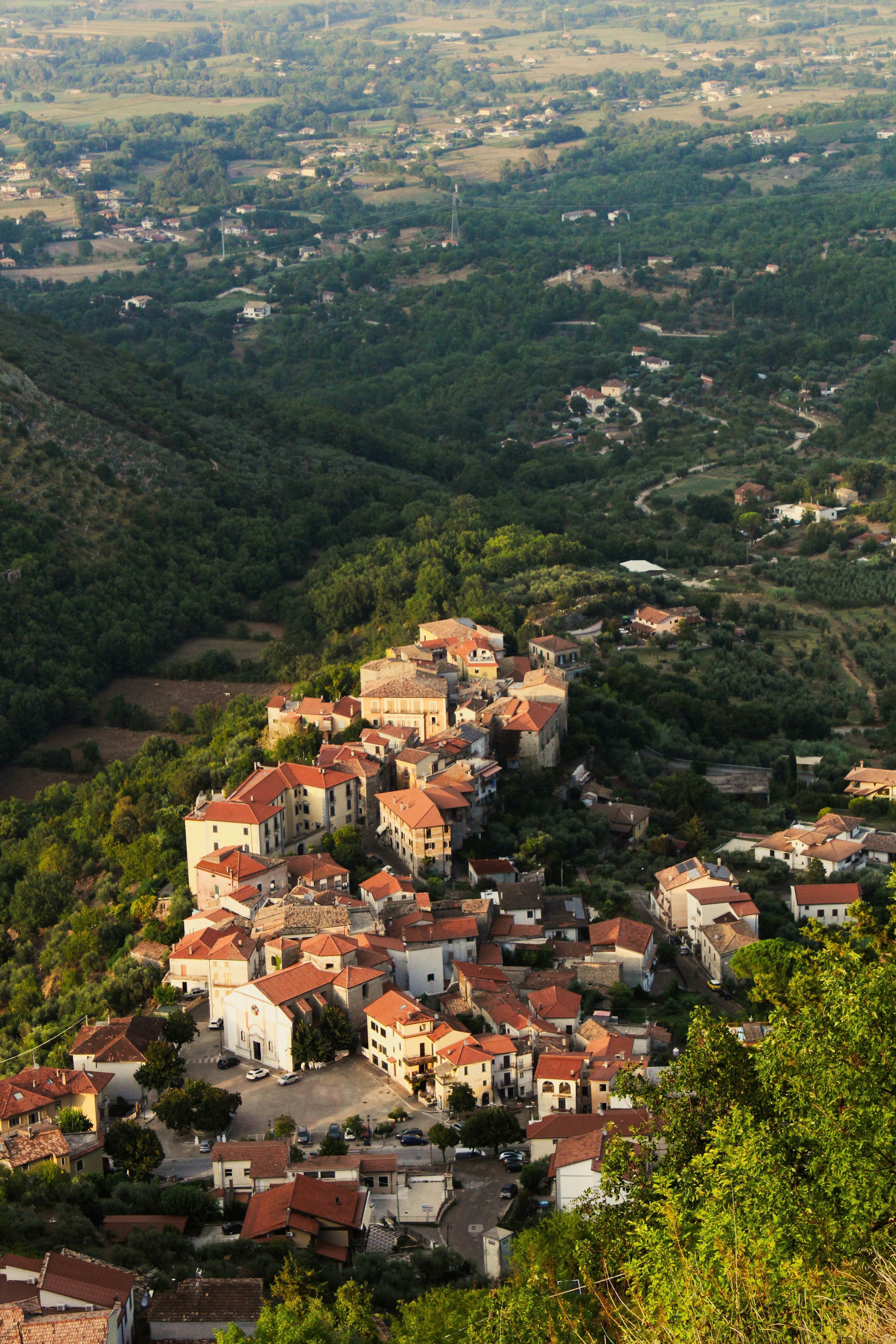 Historic village on a hillside overlooking a lush valley.