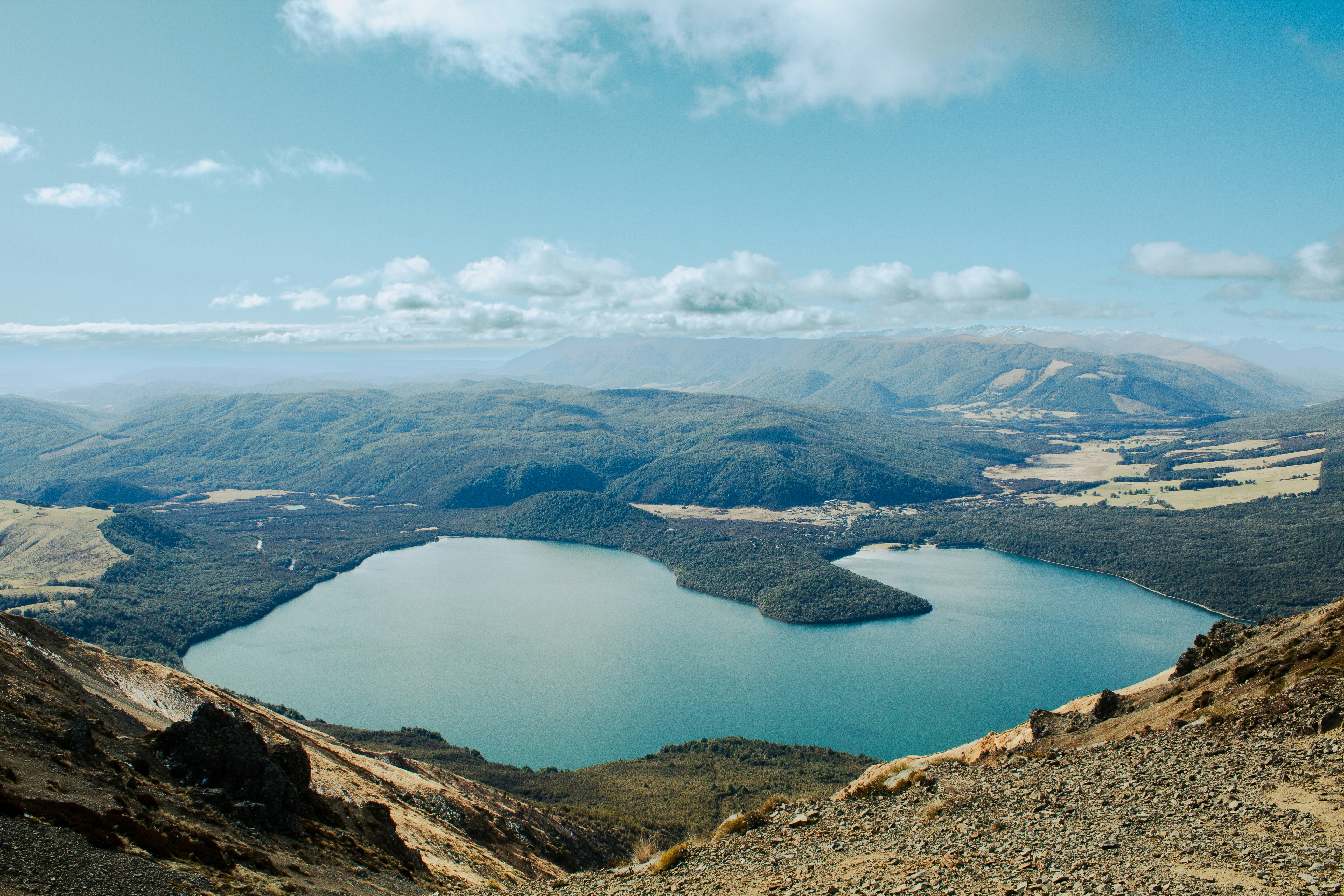 Scenic view of a lake surrounded by mountains and forests.