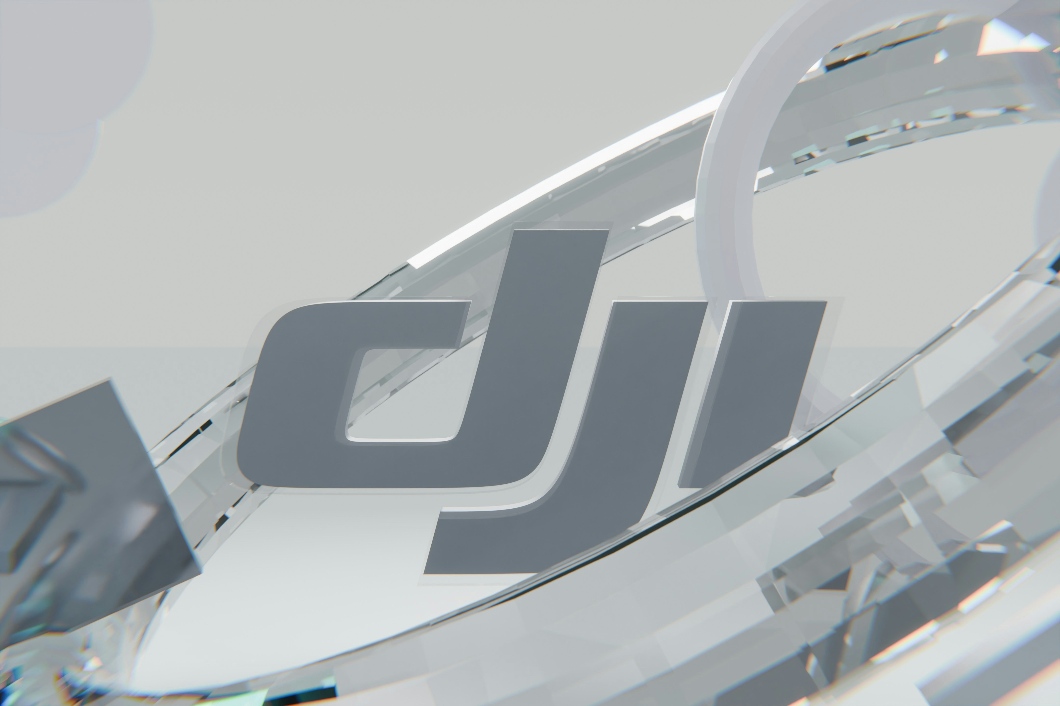 Grey dji logo surrounded by abstract clear shapes
