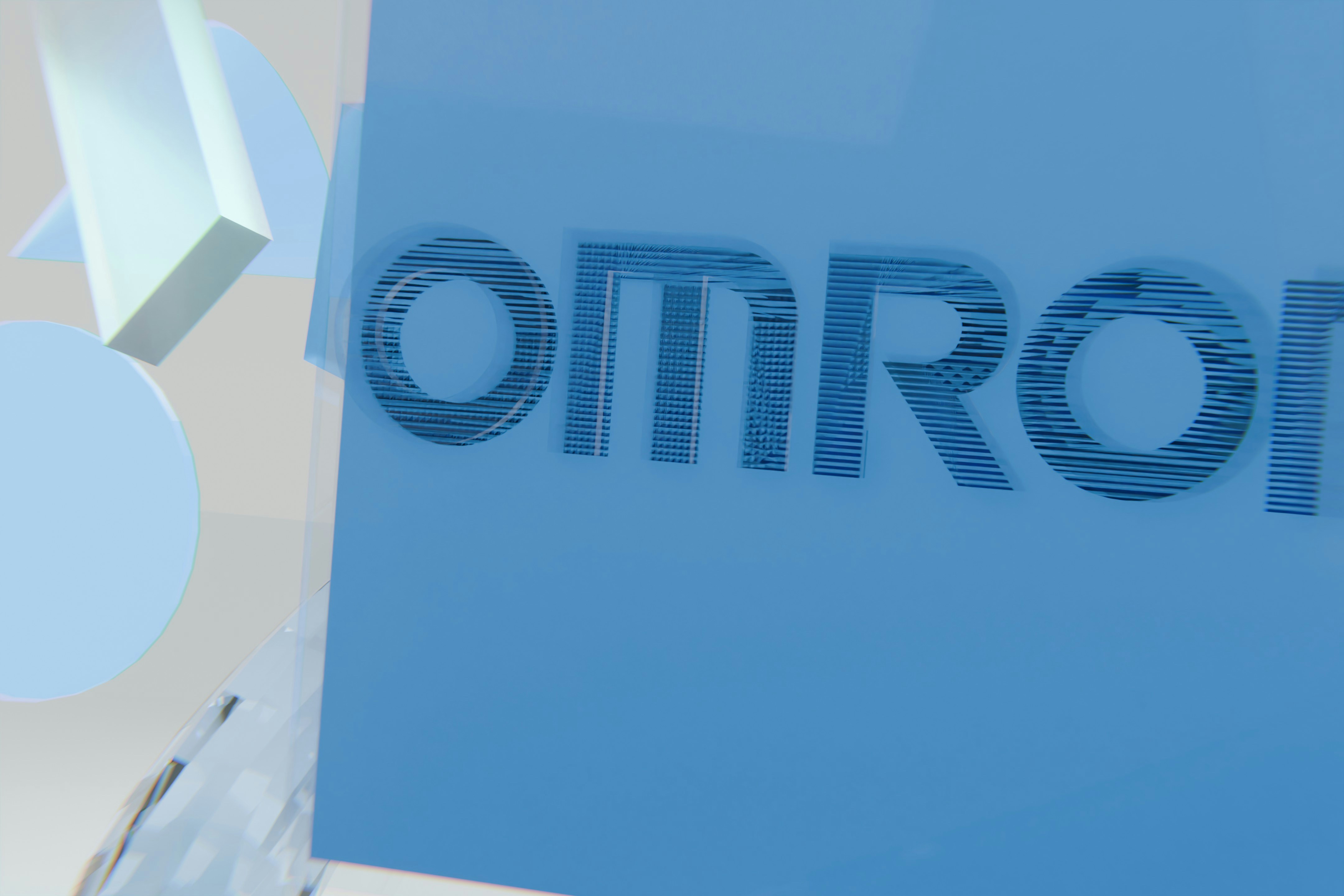 3D omron text on a blue and white geometric background