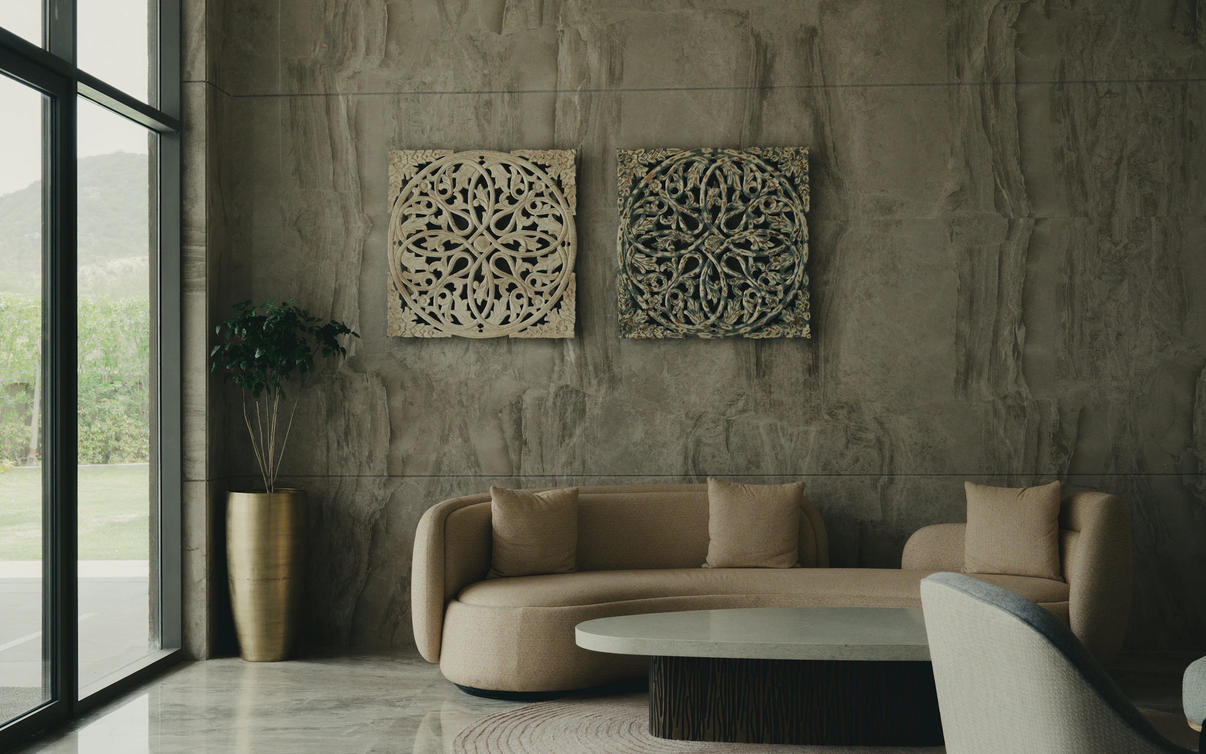 Living room with textured stone wall and curved sofa