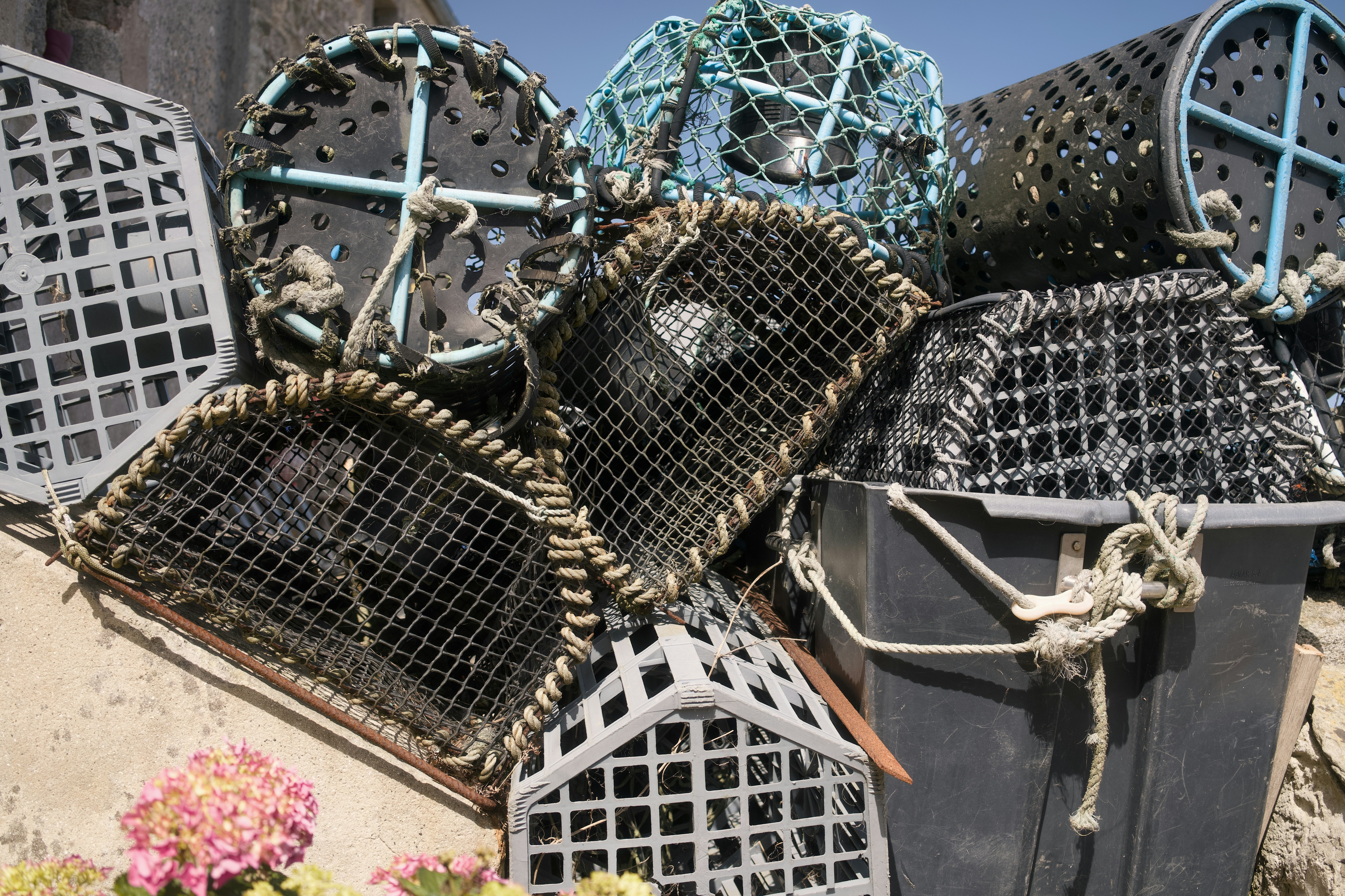 A stack of various fishing traps and lobster pots.