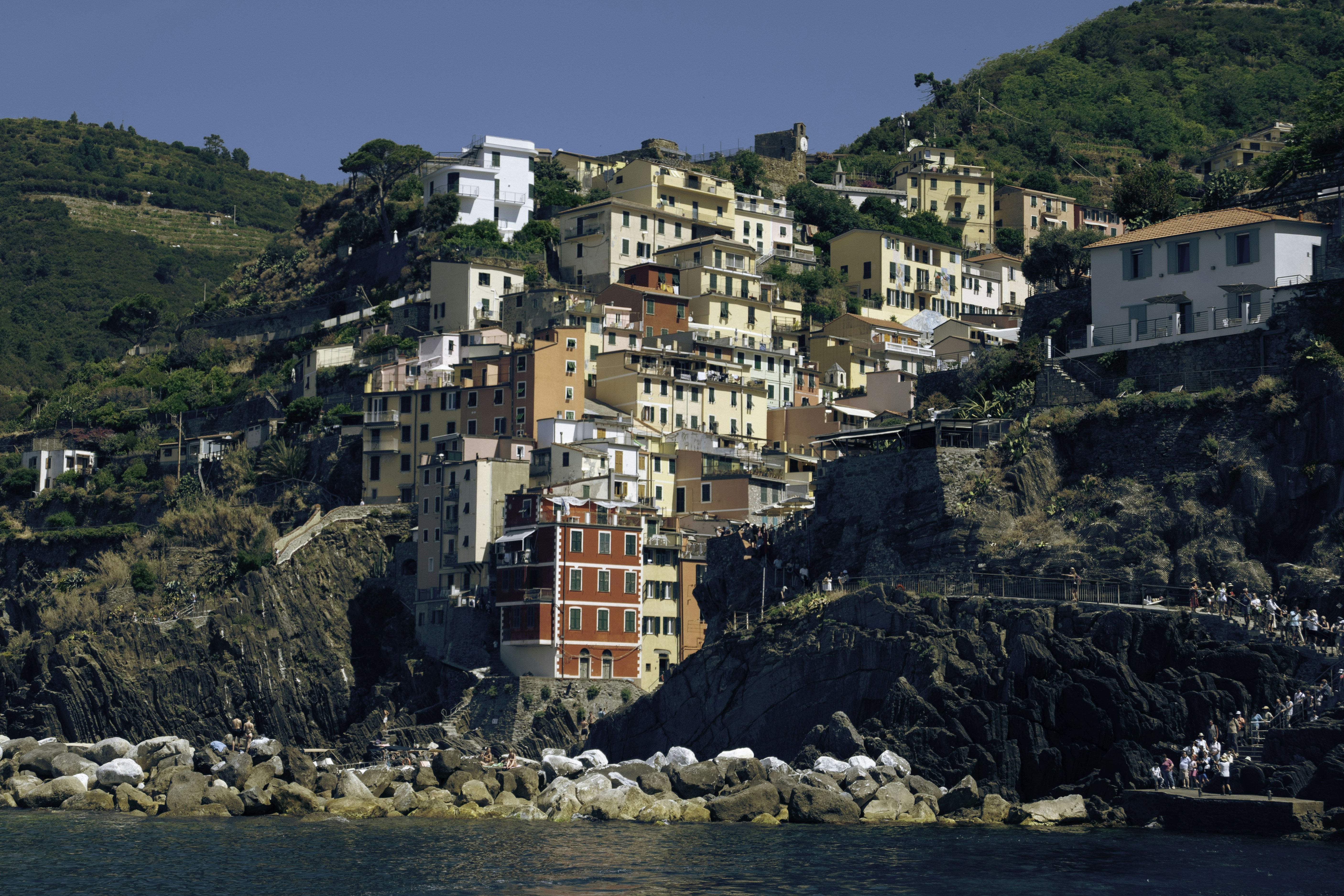Colorful buildings on a steep hillside overlooking the sea.
