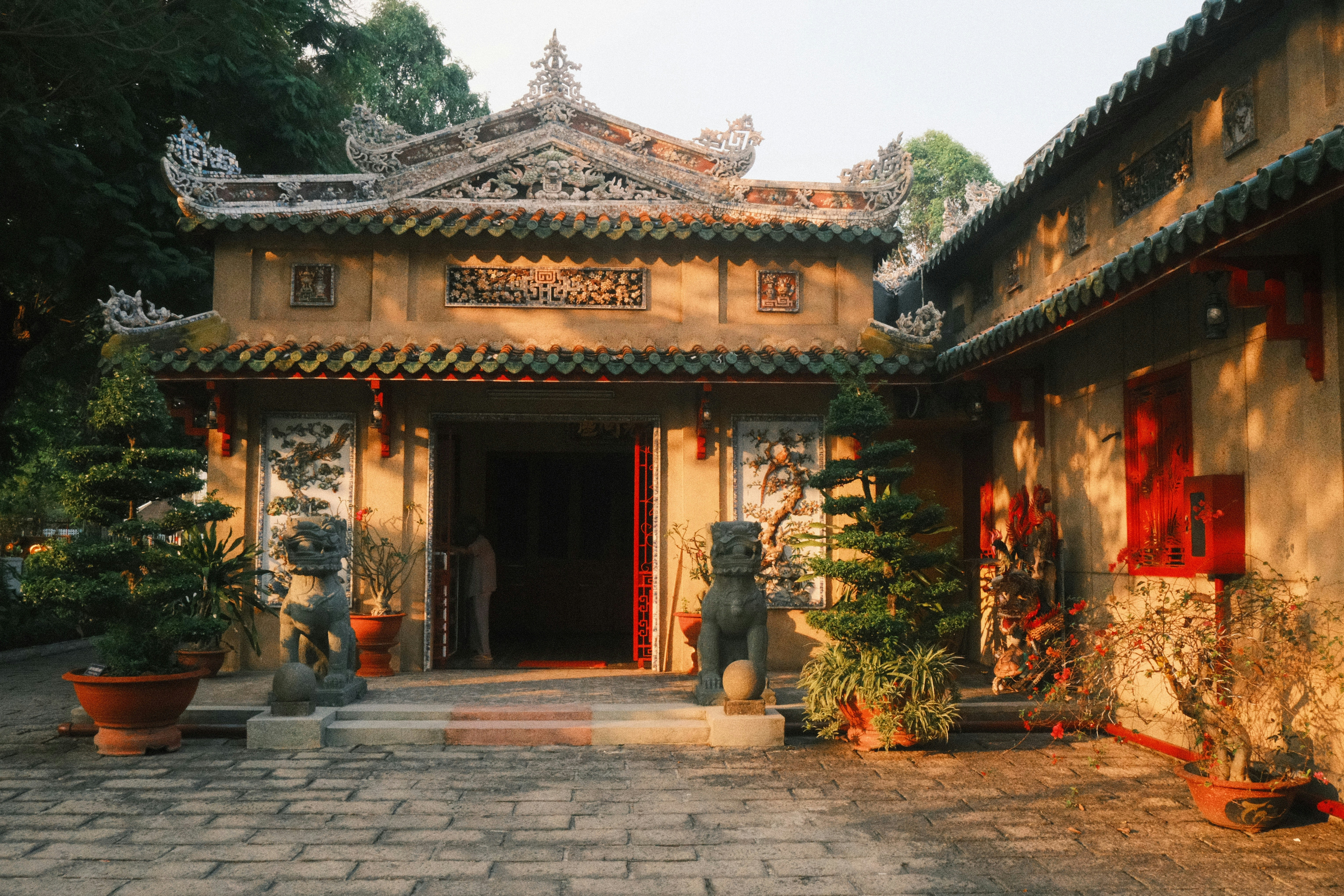 Ornate traditional asian temple building with guardian statues.