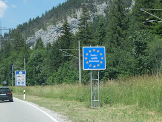 European union border sign beside a mountain road.
